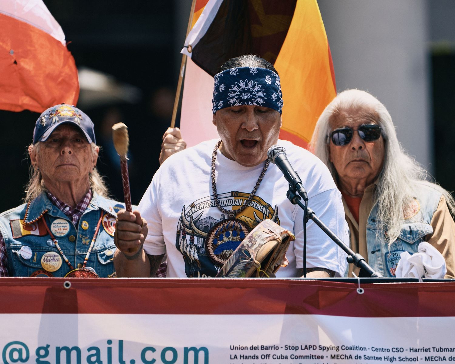 American Indian Movement elders perform a traditional land blessing from the stage at the May Day rally at City Hall, Los Angeles, May 2026.