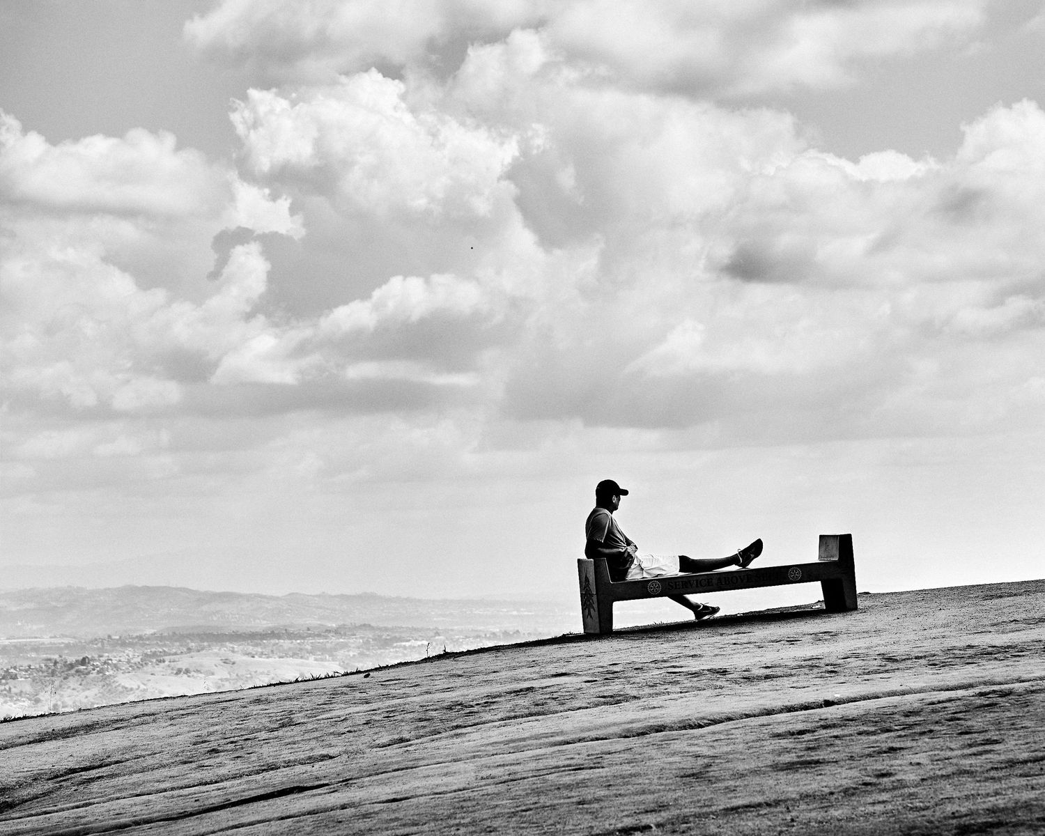 A man sits alone on a hilltop bench in Los Angeles during COVID-19 lockdown, spring 2020. (Afonso Salcedo)
