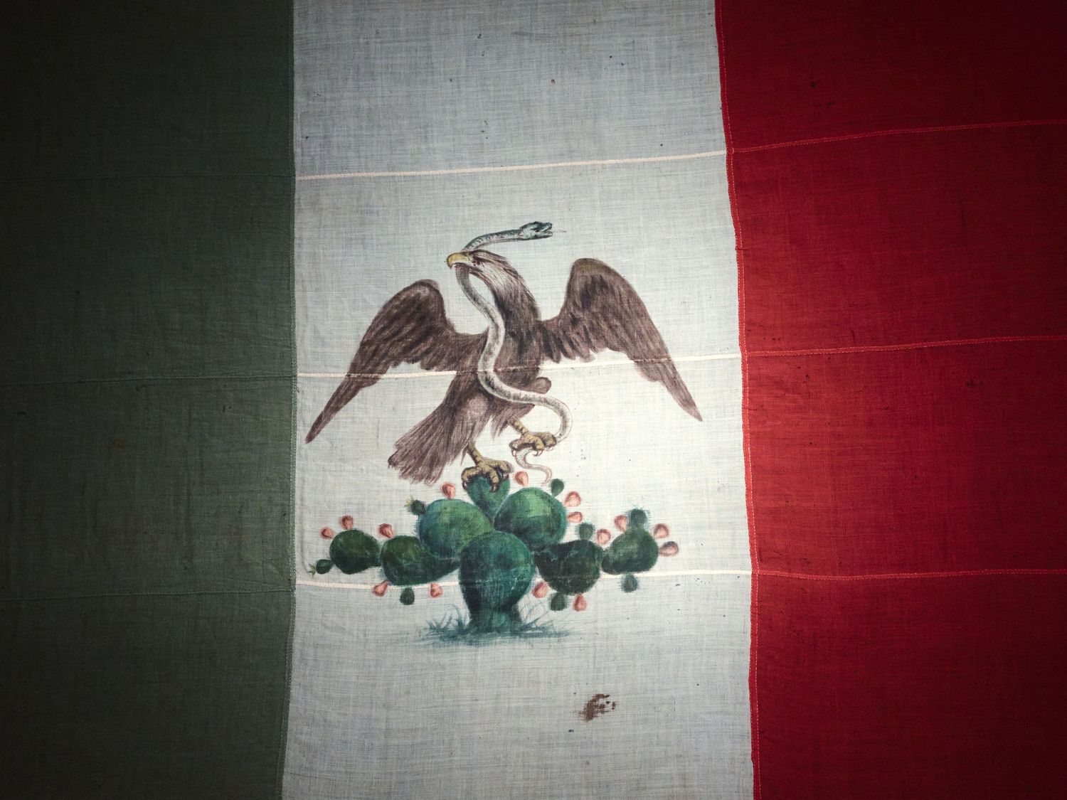 A hand-painted 19th-century Mexican flag, its eagle and serpent above a nopal cactus, at the Autry’s “Life, Liberty, and Los Angeles.”