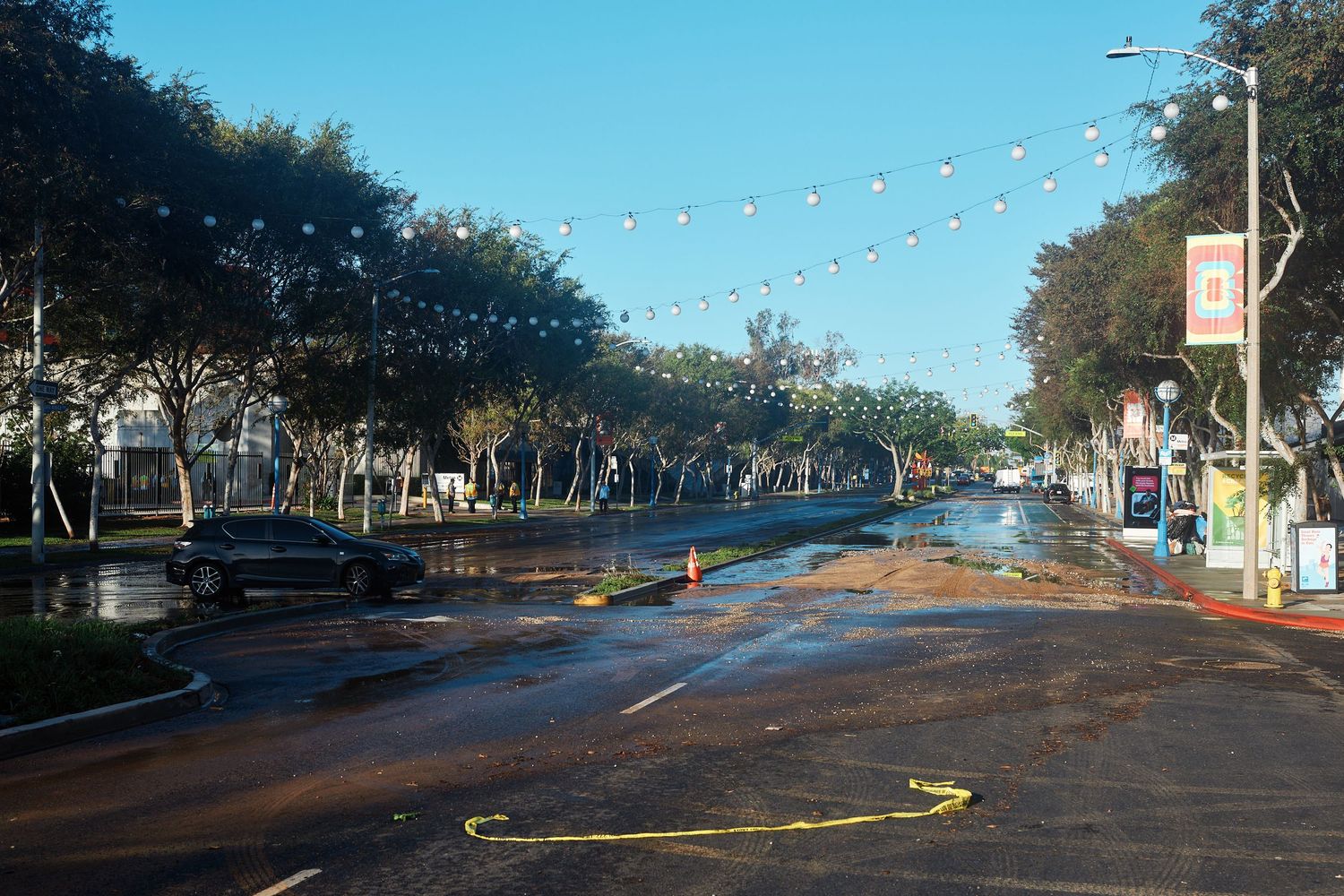 Silt and mud cover a closed stretch of Santa Monica Boulevard after floodwaters from the morning's water main break drained