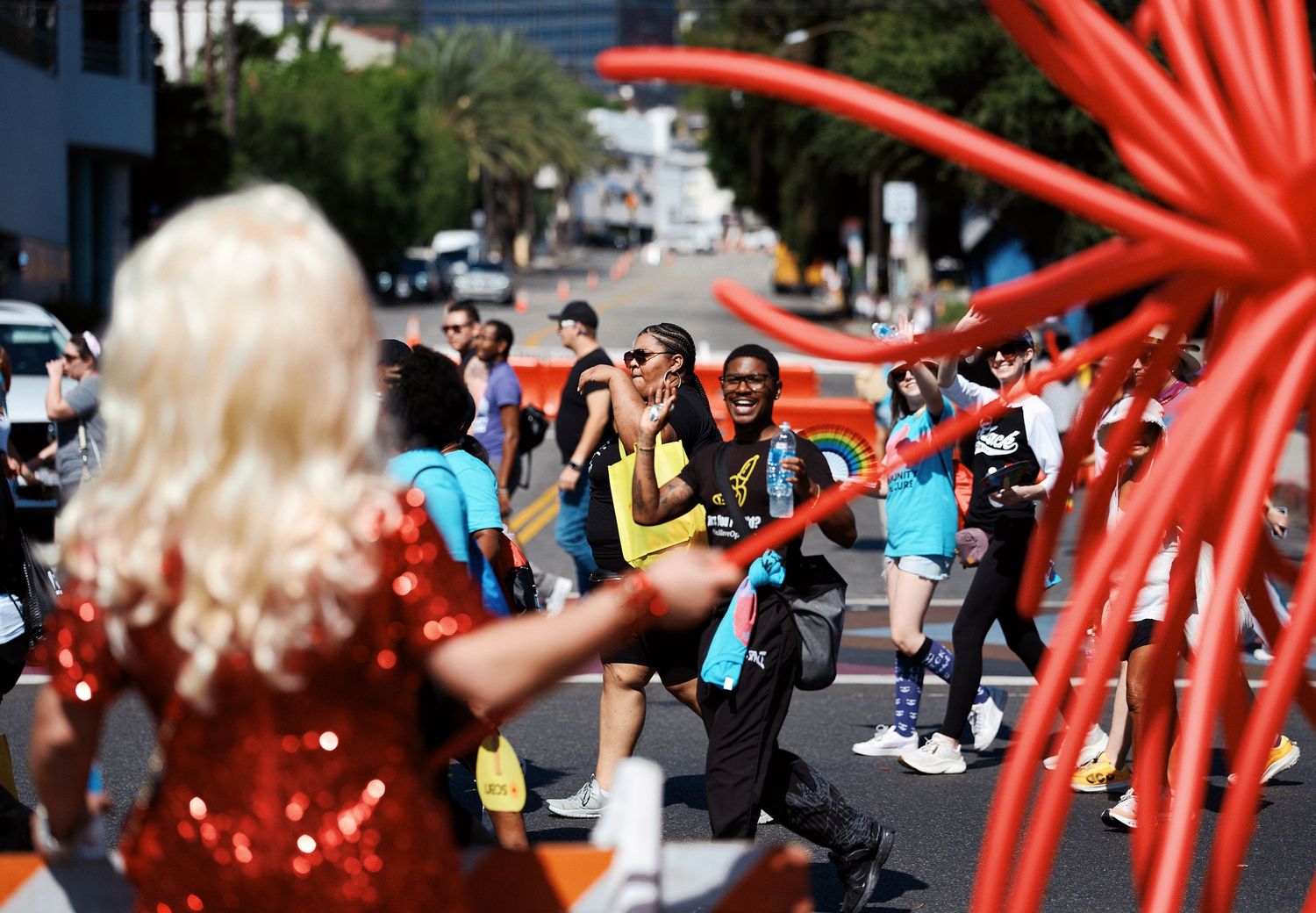 Large red balloon sculptures create an eye-catching art installation at an outdoor public event.
