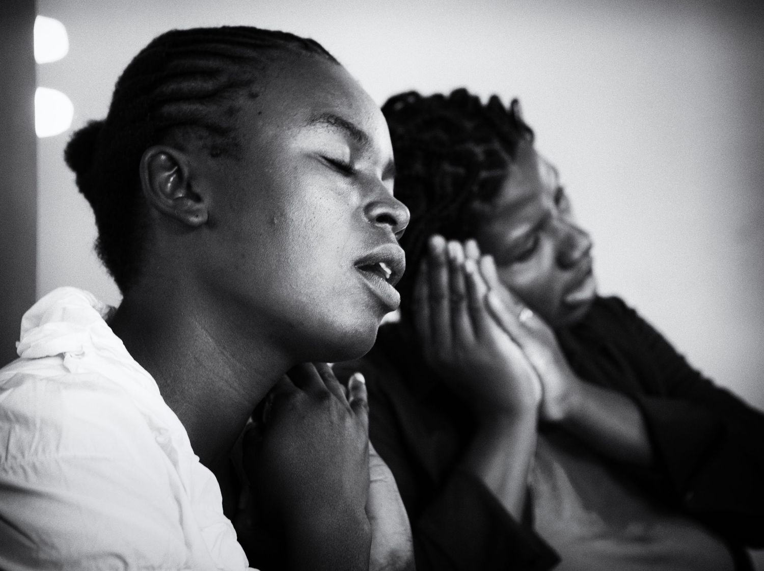 Women pray during a community gathering in Fond Parisien, Haiti, Sept. 2013. (Afonso Salcedo)