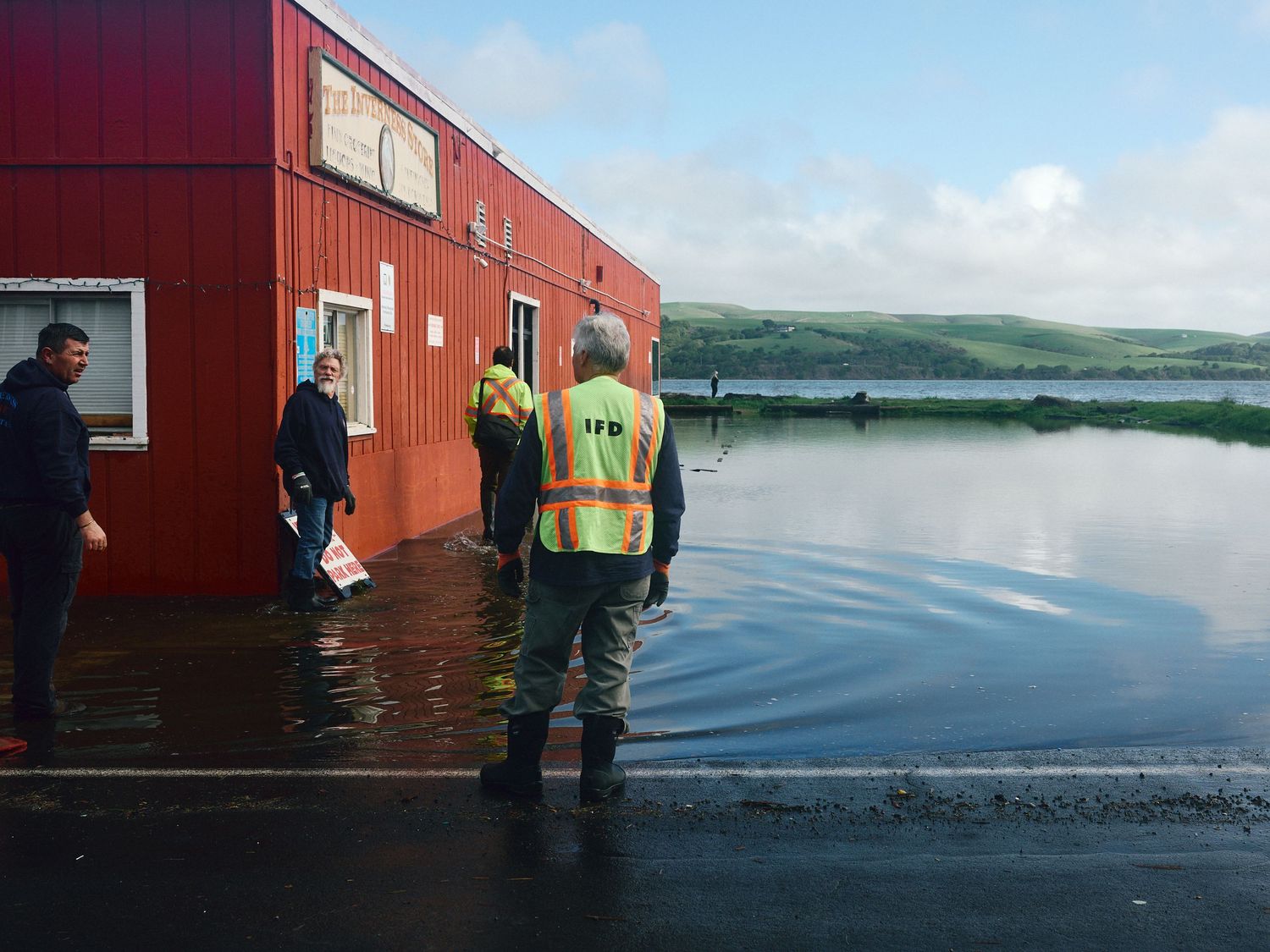 Inverness Fire Dept. responders assess flooding at The Inverness Store, Calif., Jan. 3, 2026. (Afonso Salcedo)