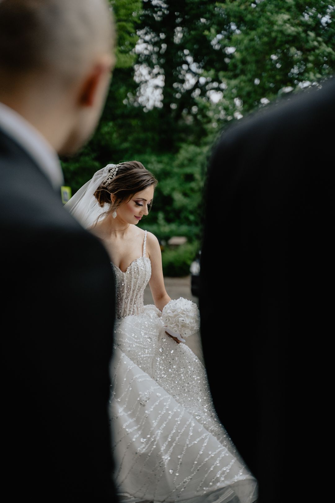 a wedding shot of a bride between 2 men