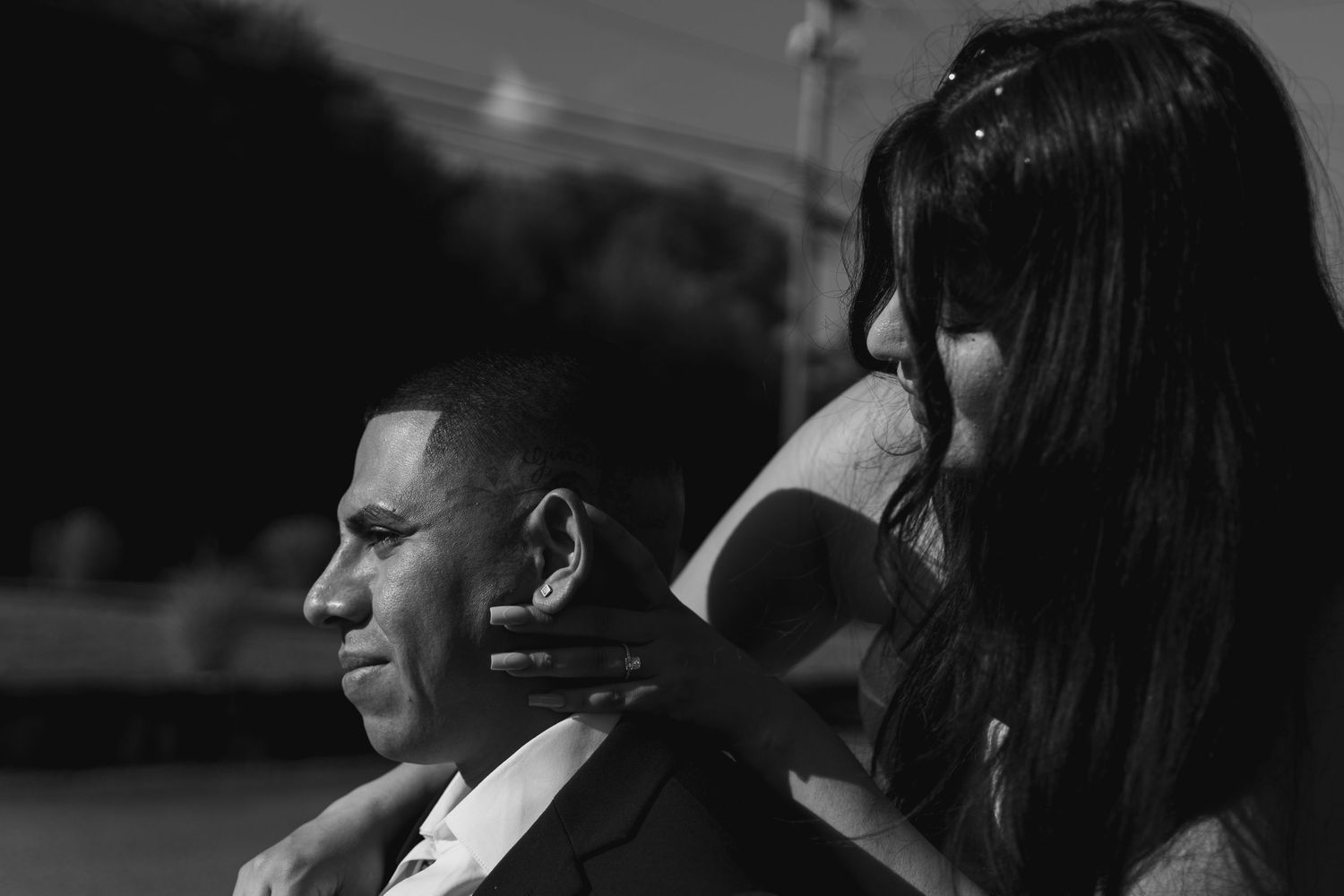 A black and white image of a woman with her arms around a man. Shot at The Barn at Twiggys in Middletown, New York.