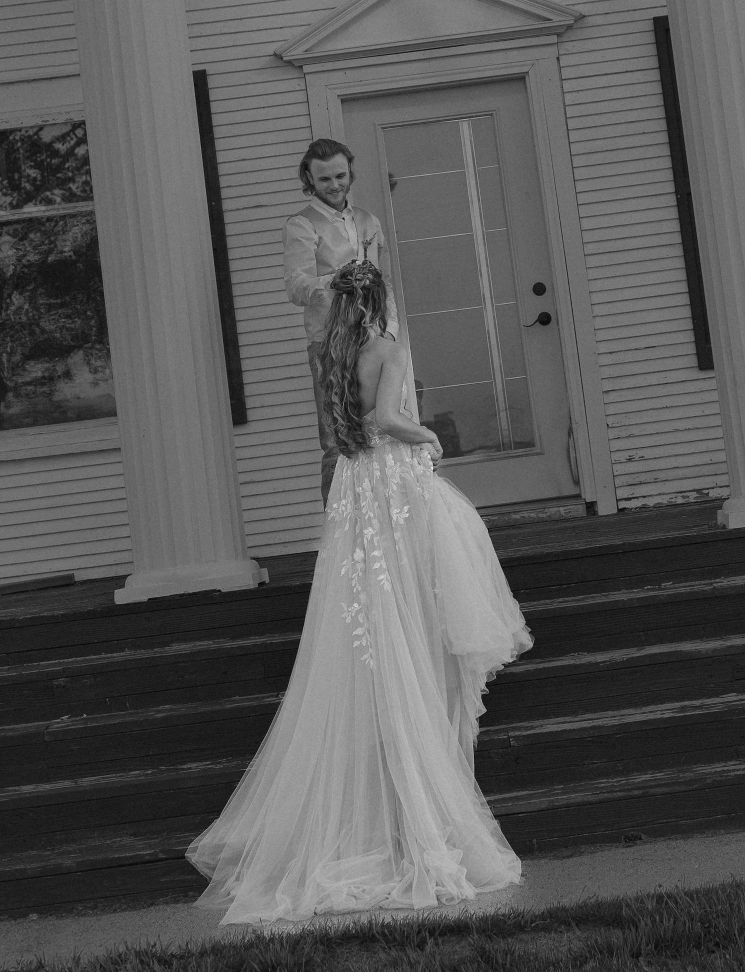 A series of black and white wedding portraits showing a bride in a flowing dress on outdoor steps.