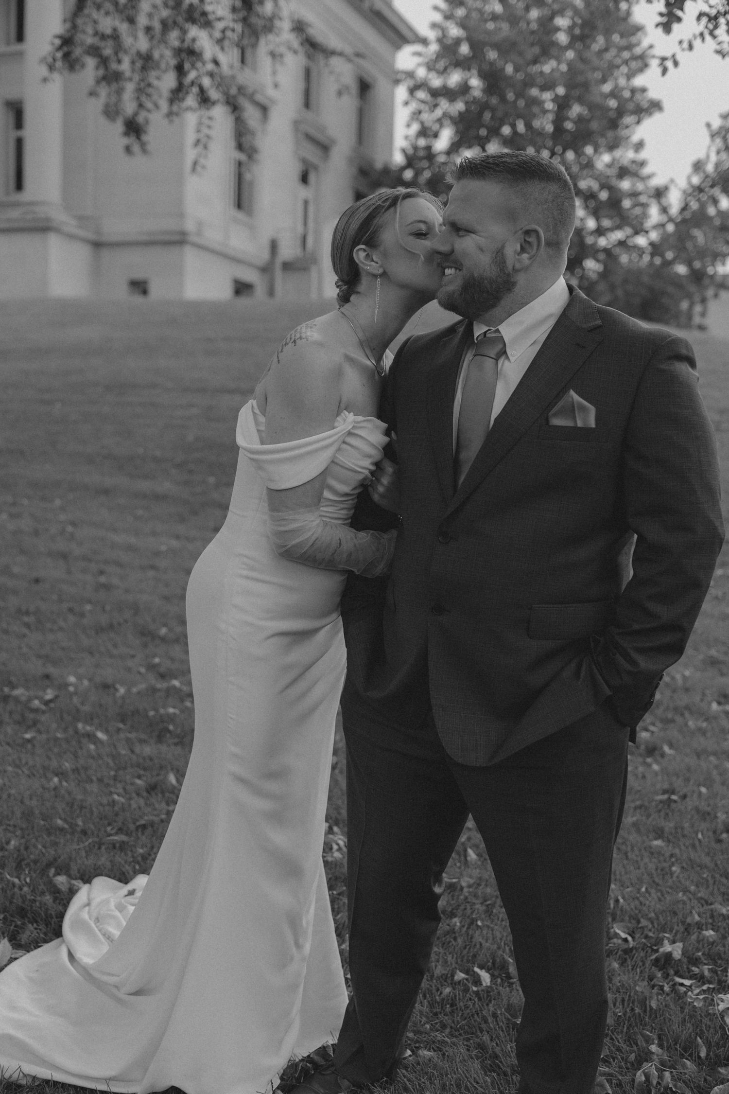 bride kissing grooms cheek in Bismarck