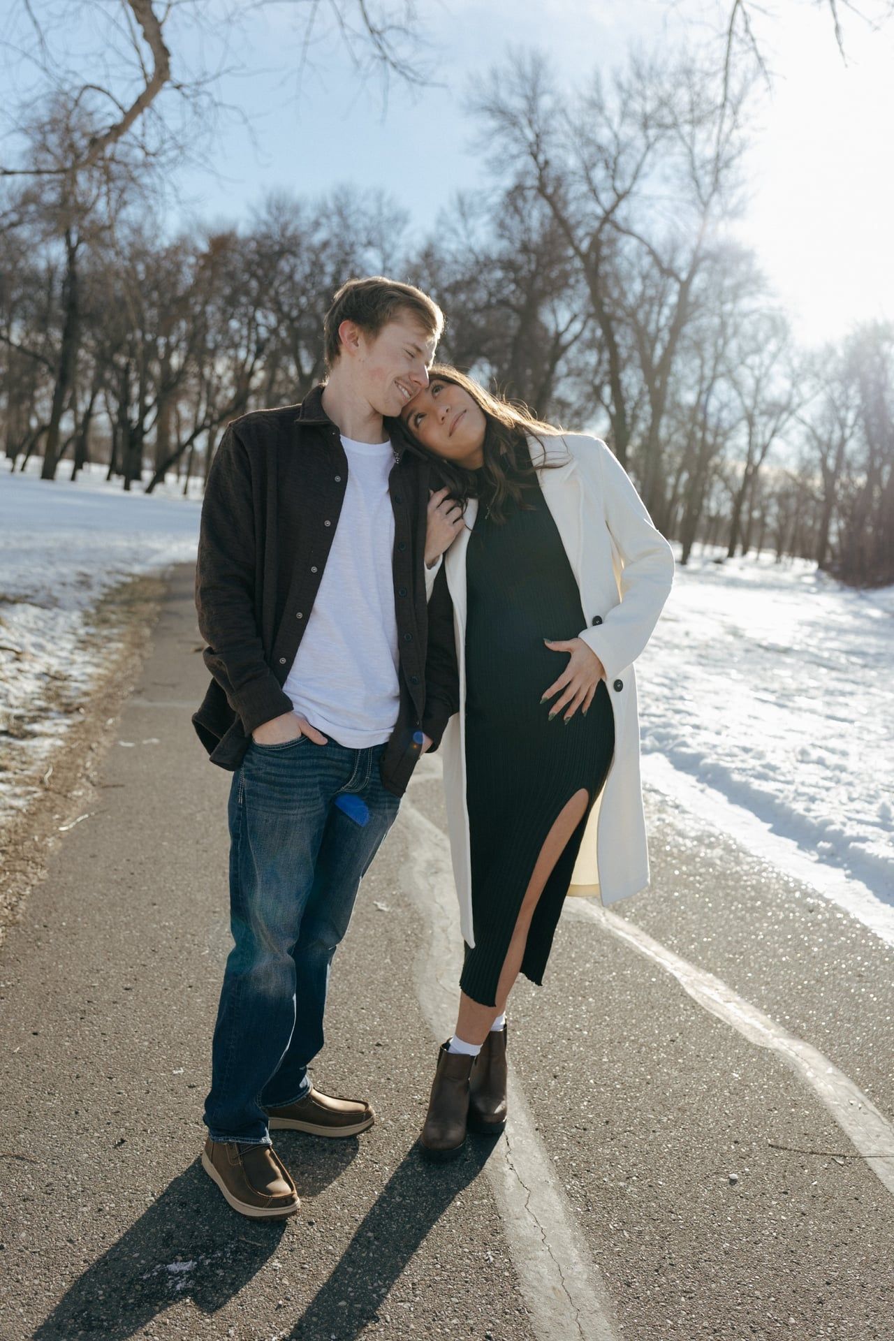 Couple smiling at each other in snowy park