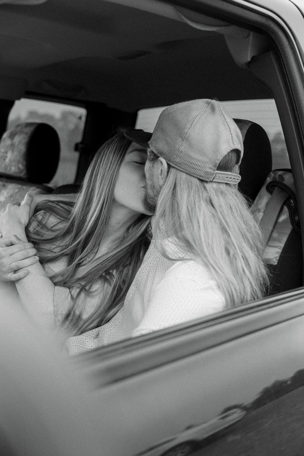 couple kissing in truck in Bismarck for engagement session