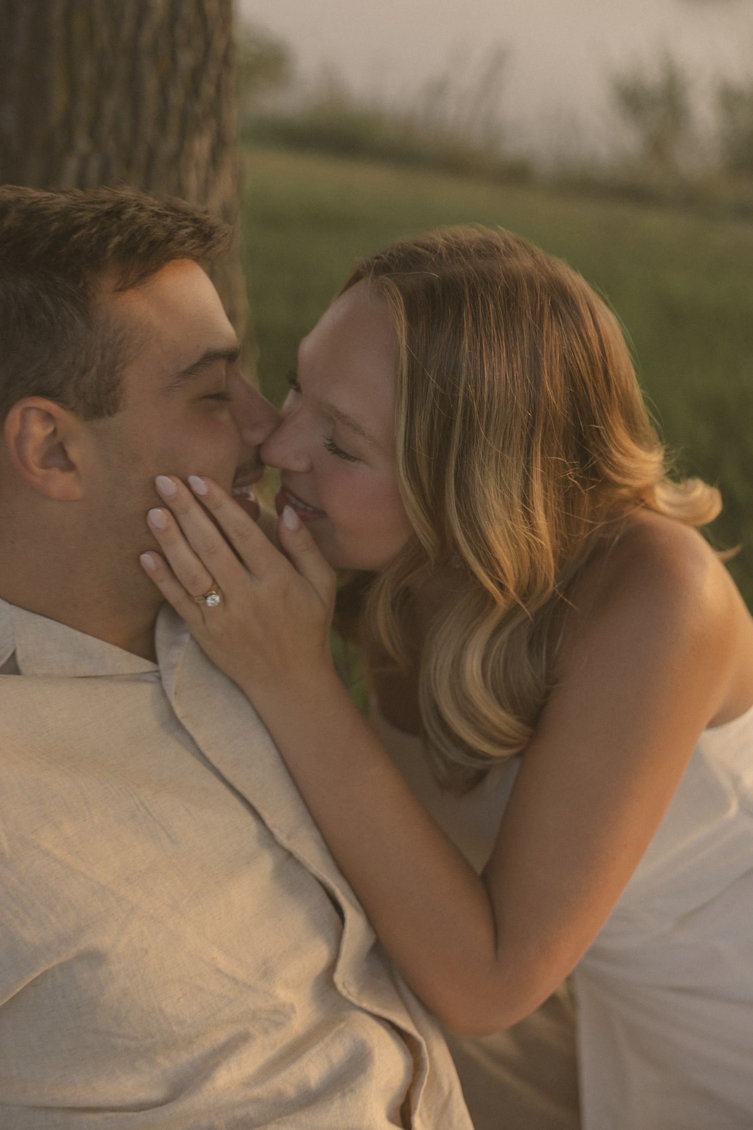 An intimate close-up of a couple sharing a romantic moment during golden hour.