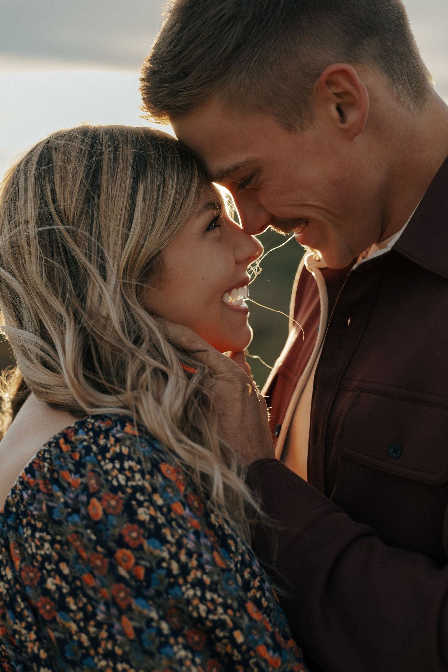 Intimate close-up portrait with golden sunlight creating a warm glow.