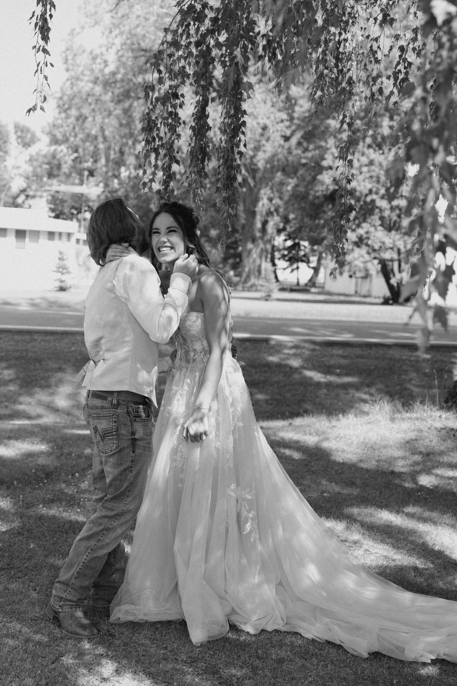 Black and white wedding photography session under weeping willow trees.