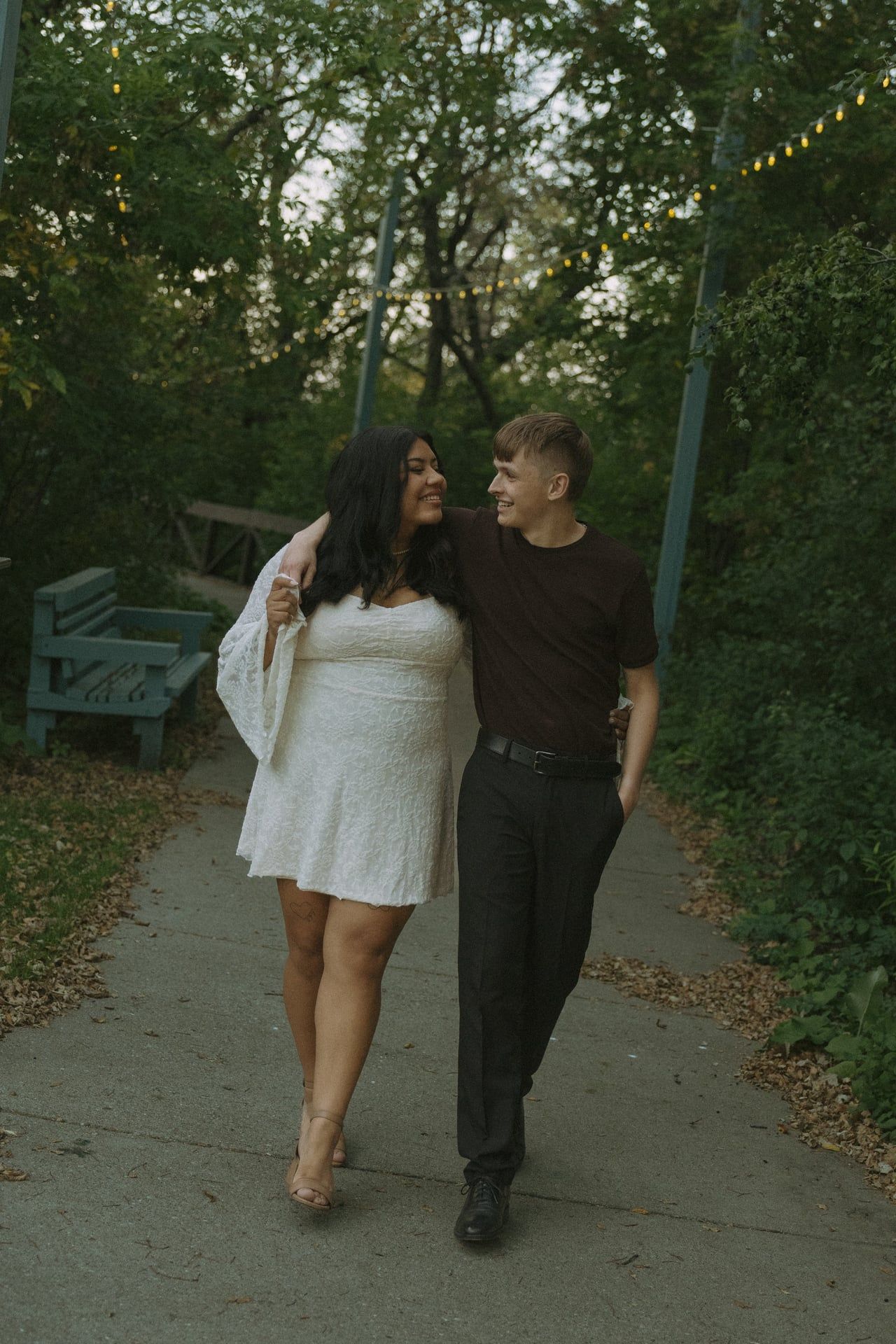 couple walking together in beautiful trees walking path