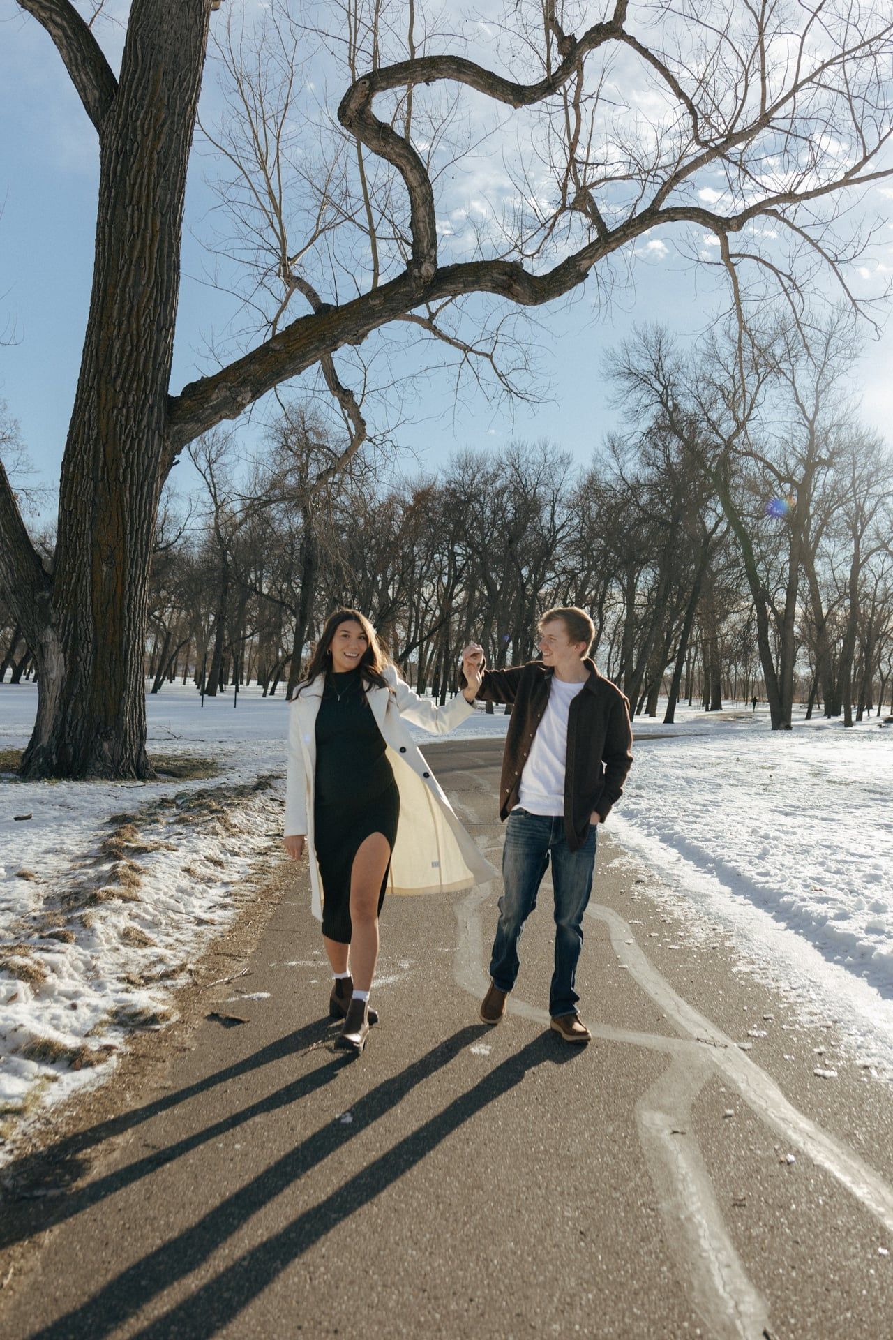 couple walking together in snowy park