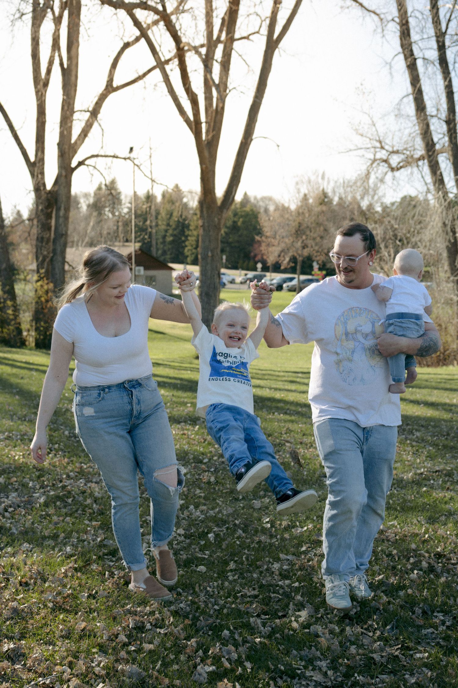 family swinging toddler for family photos in Bismarck park