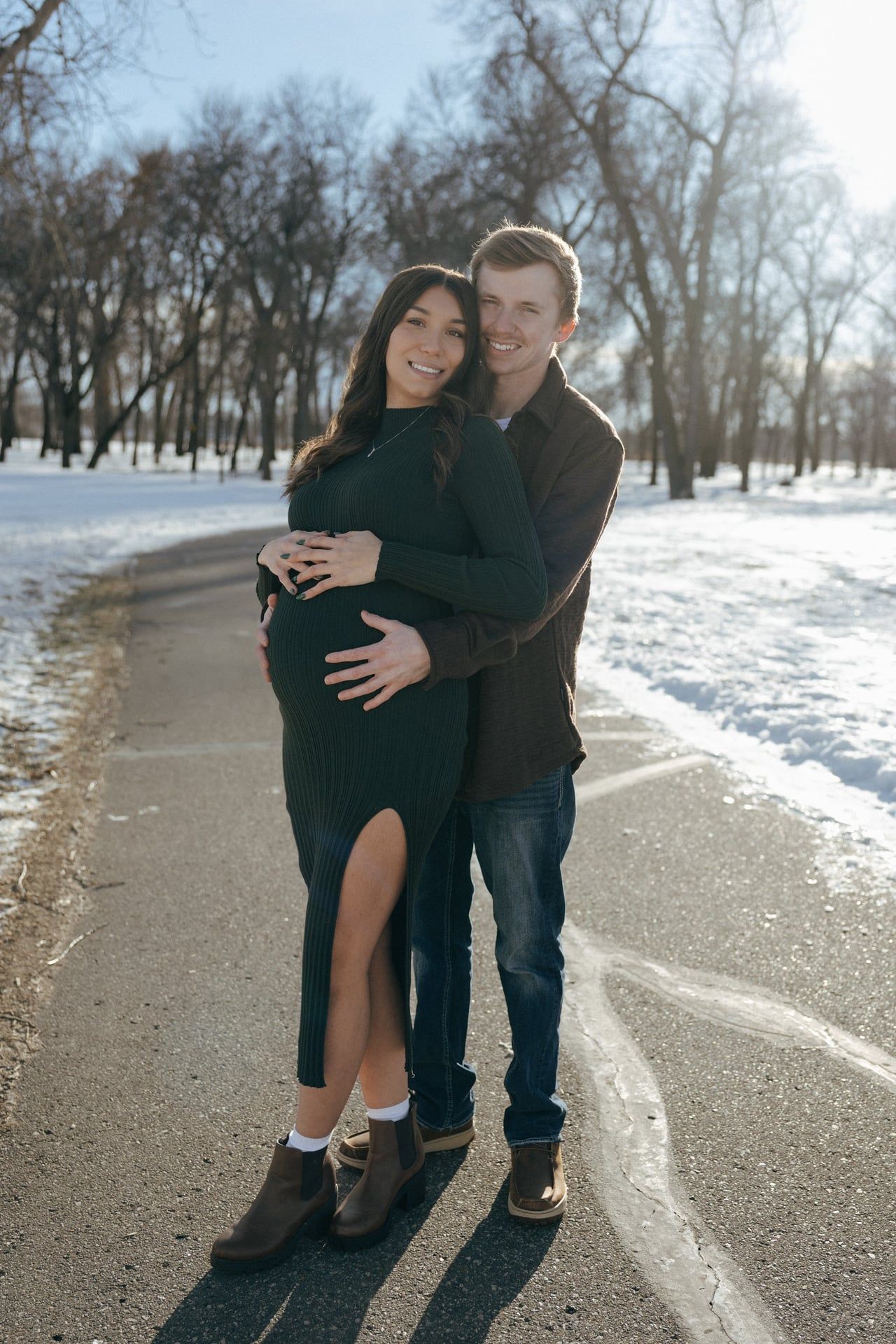 Couple hugging in snowy park in Bismarck