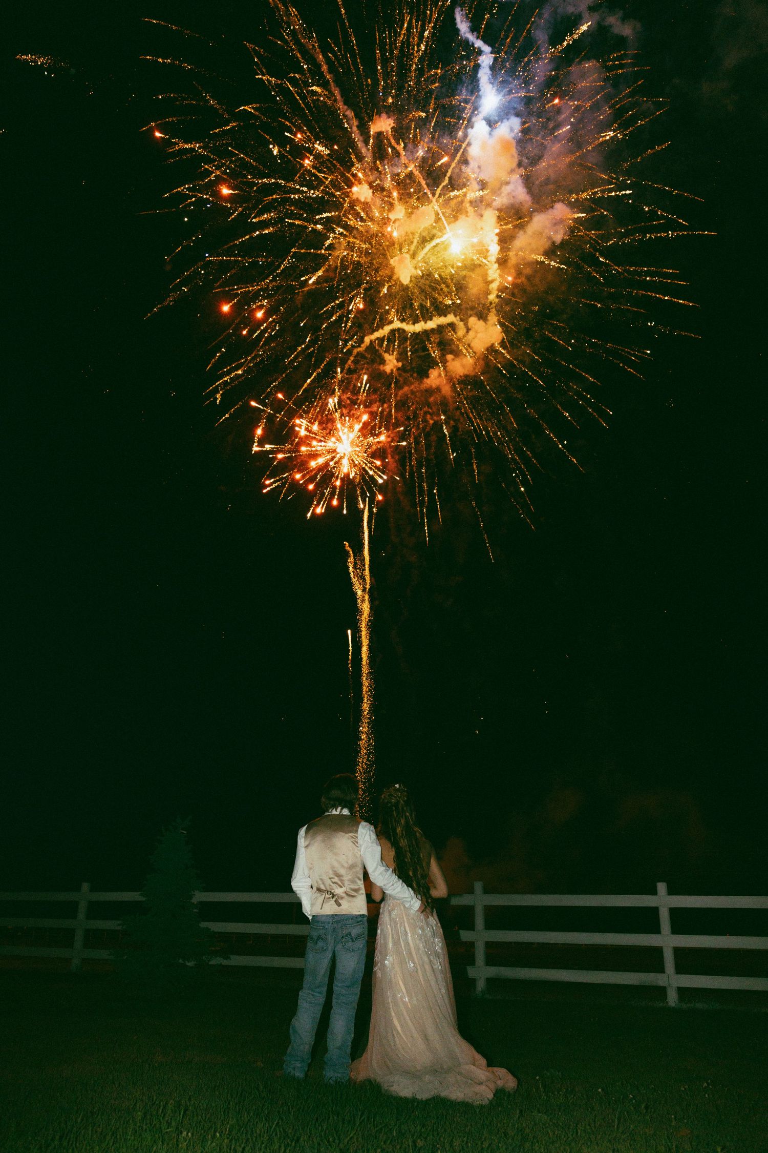 bride and groom watching fireworks together