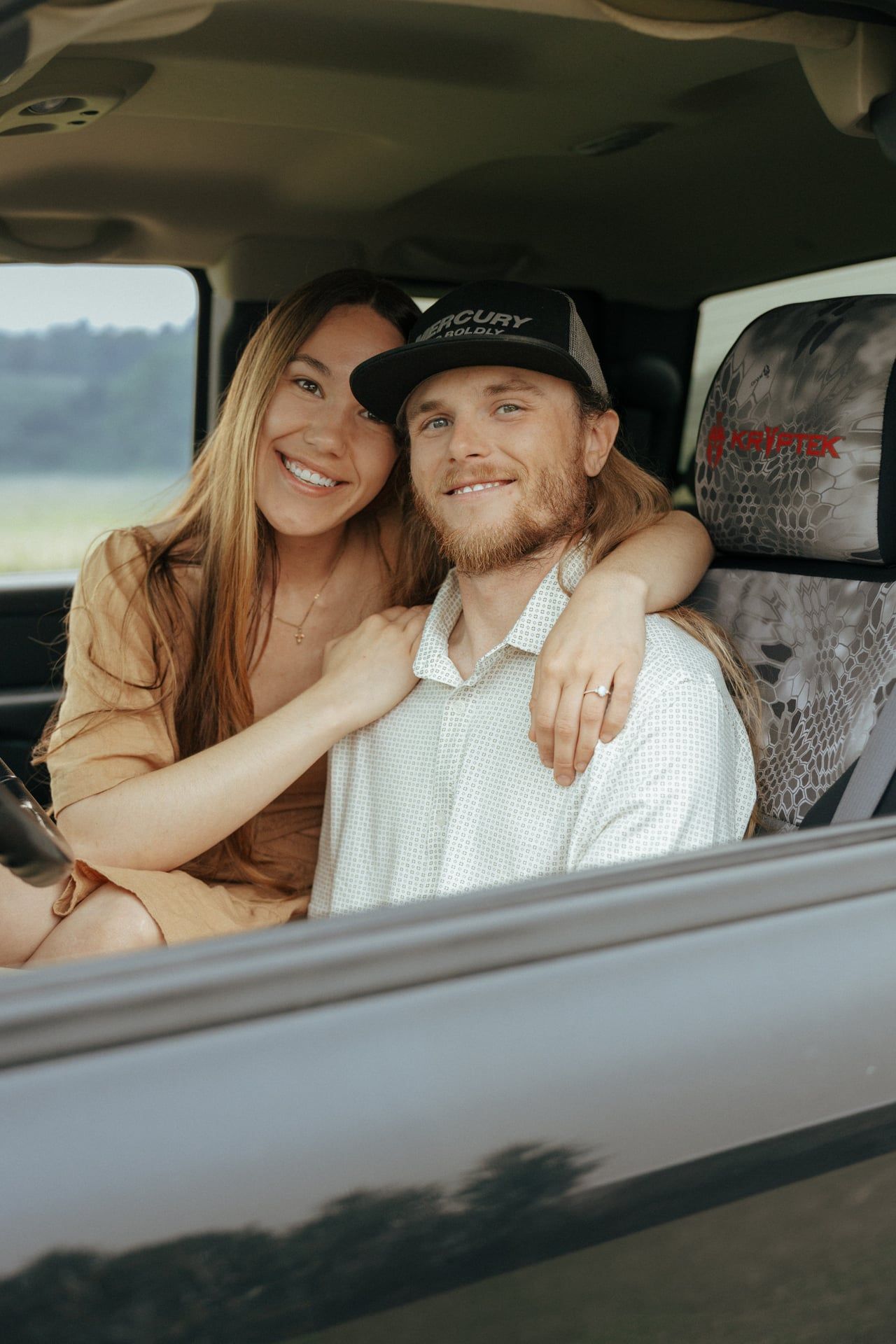couple in truck smiling at camera