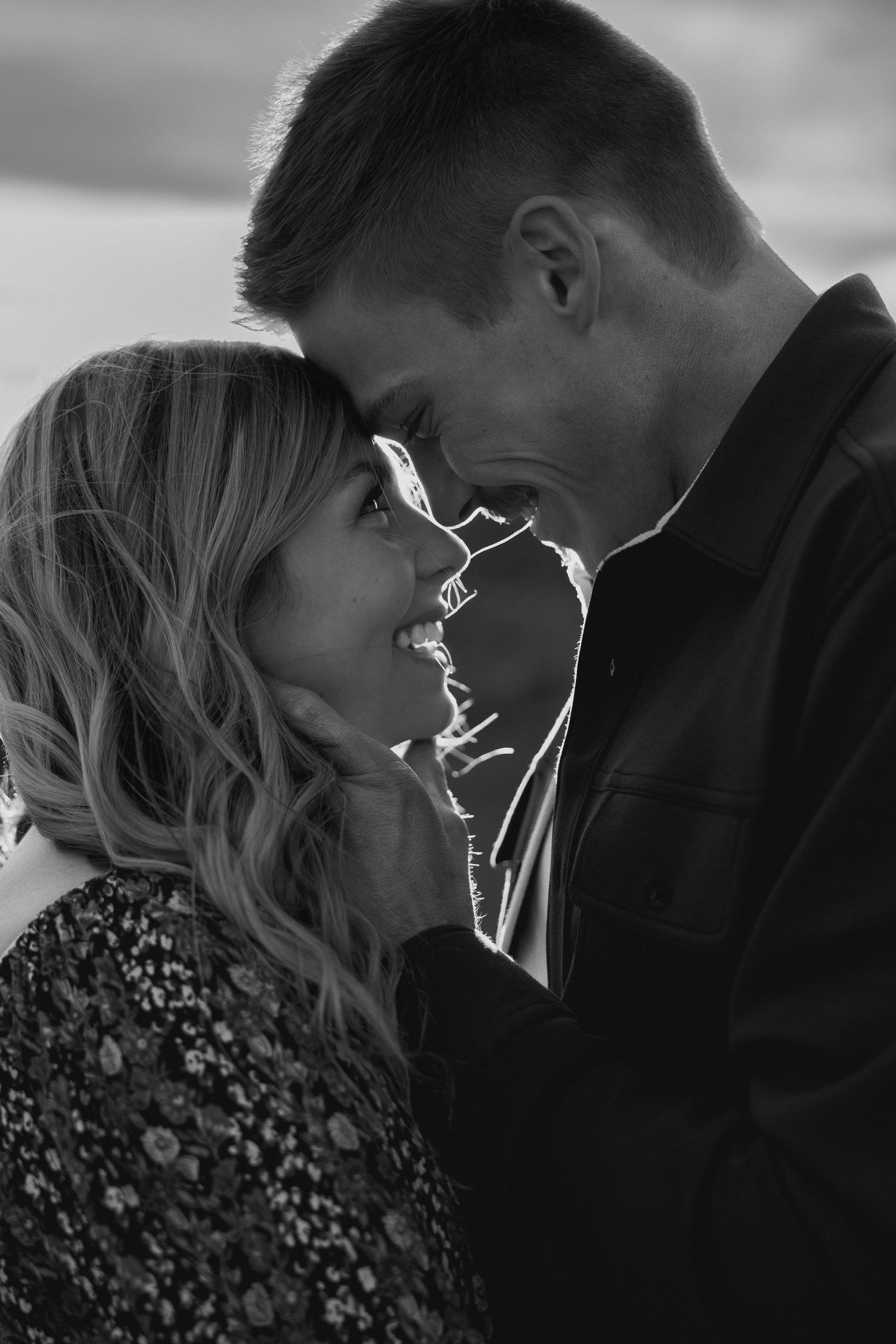 Black and white intimate portrait with dramatic lighting and shadows.