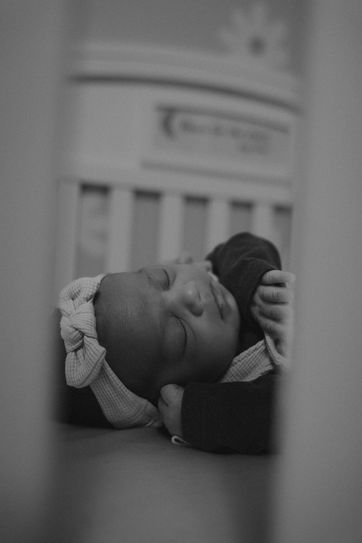 newborn laying in crib for at home newborn session