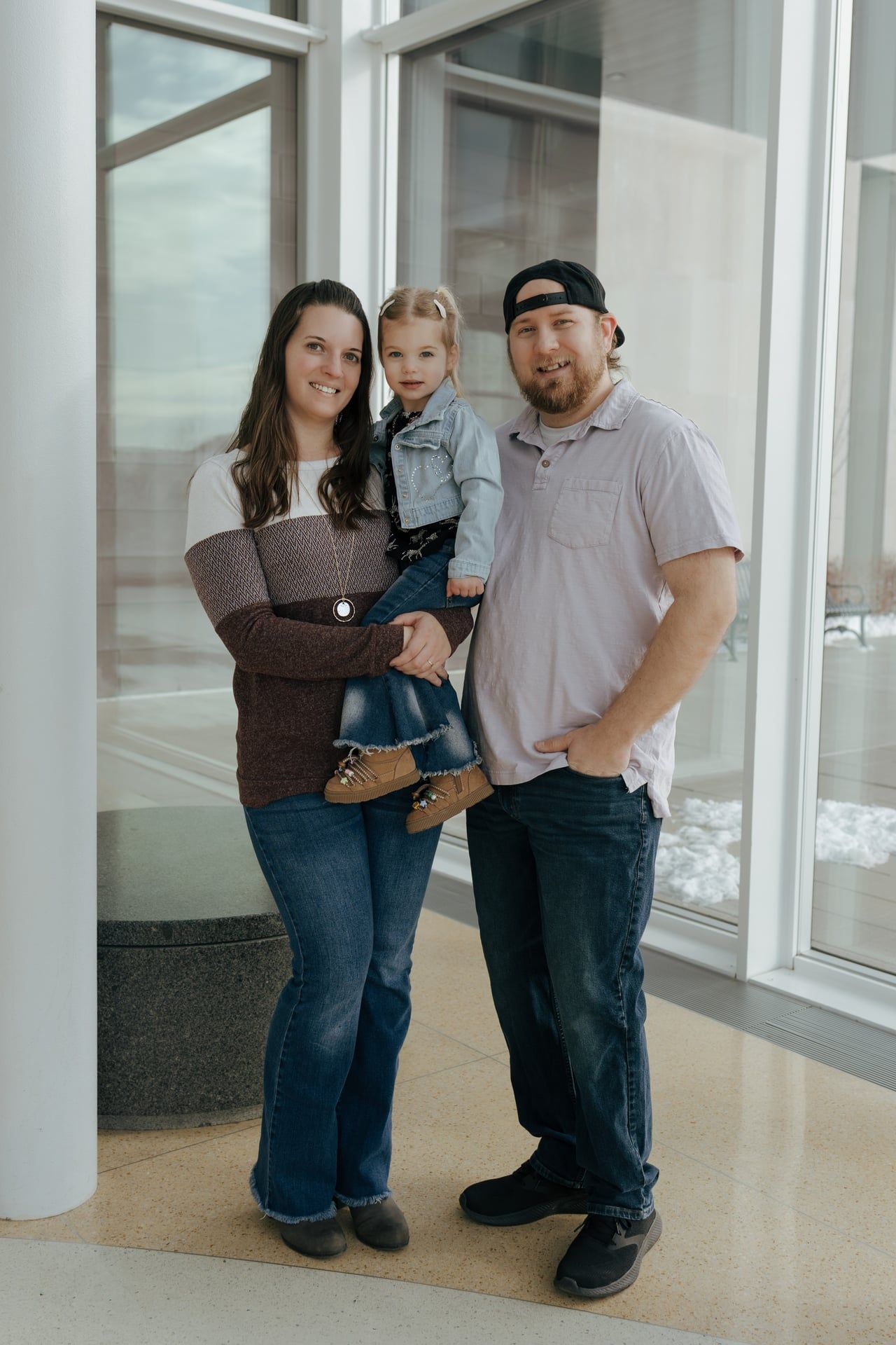 family standing together smiling at camera for family photos