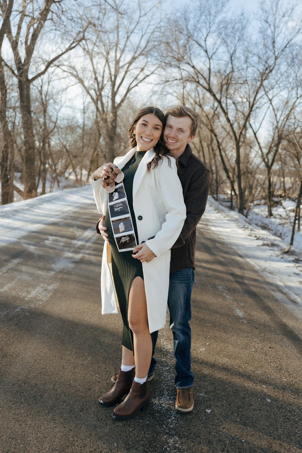 Couple in snowy trees in Bismarck with ultrasound photos
