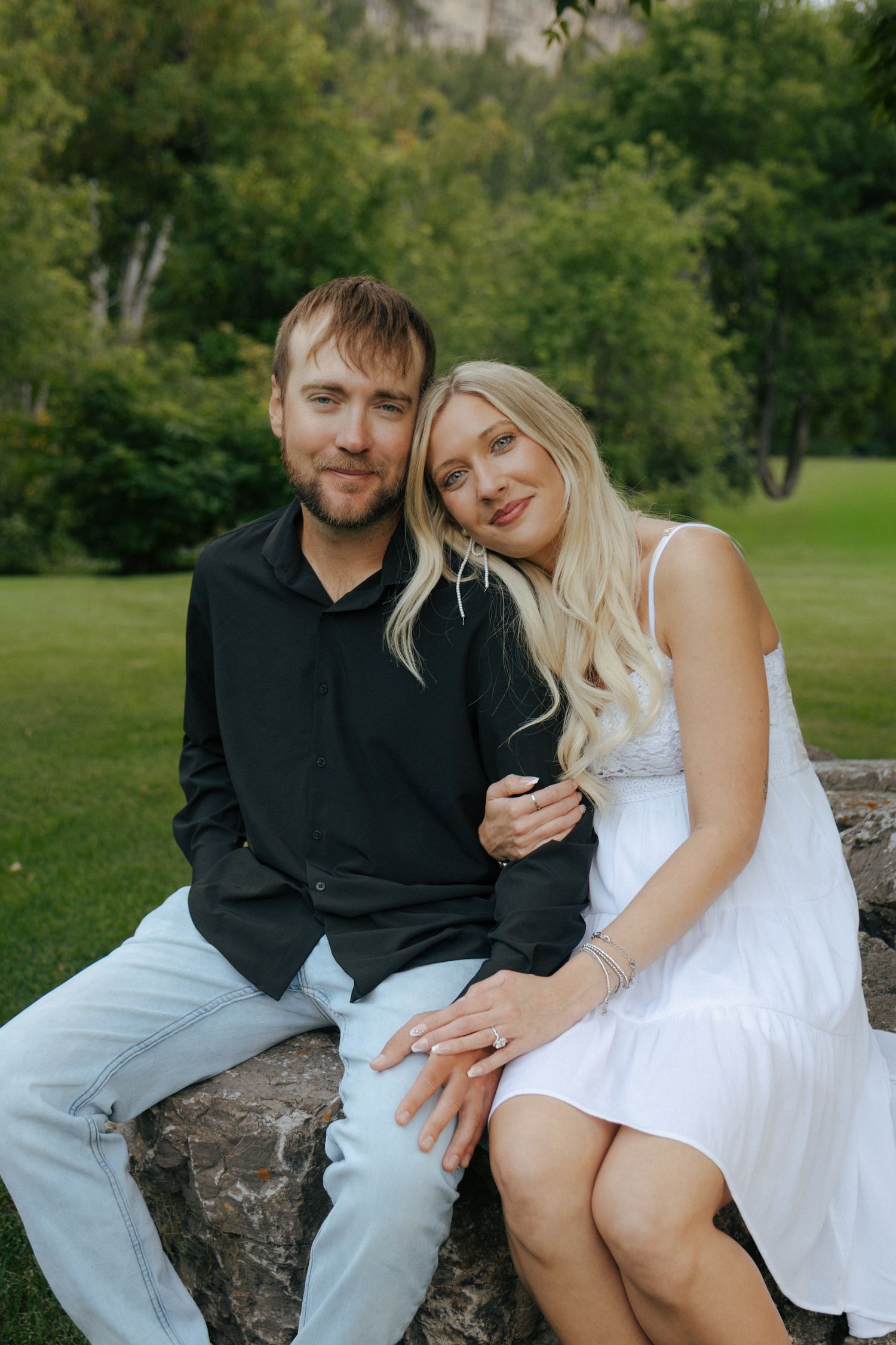 couple smiling at camera in black hills for engagement session