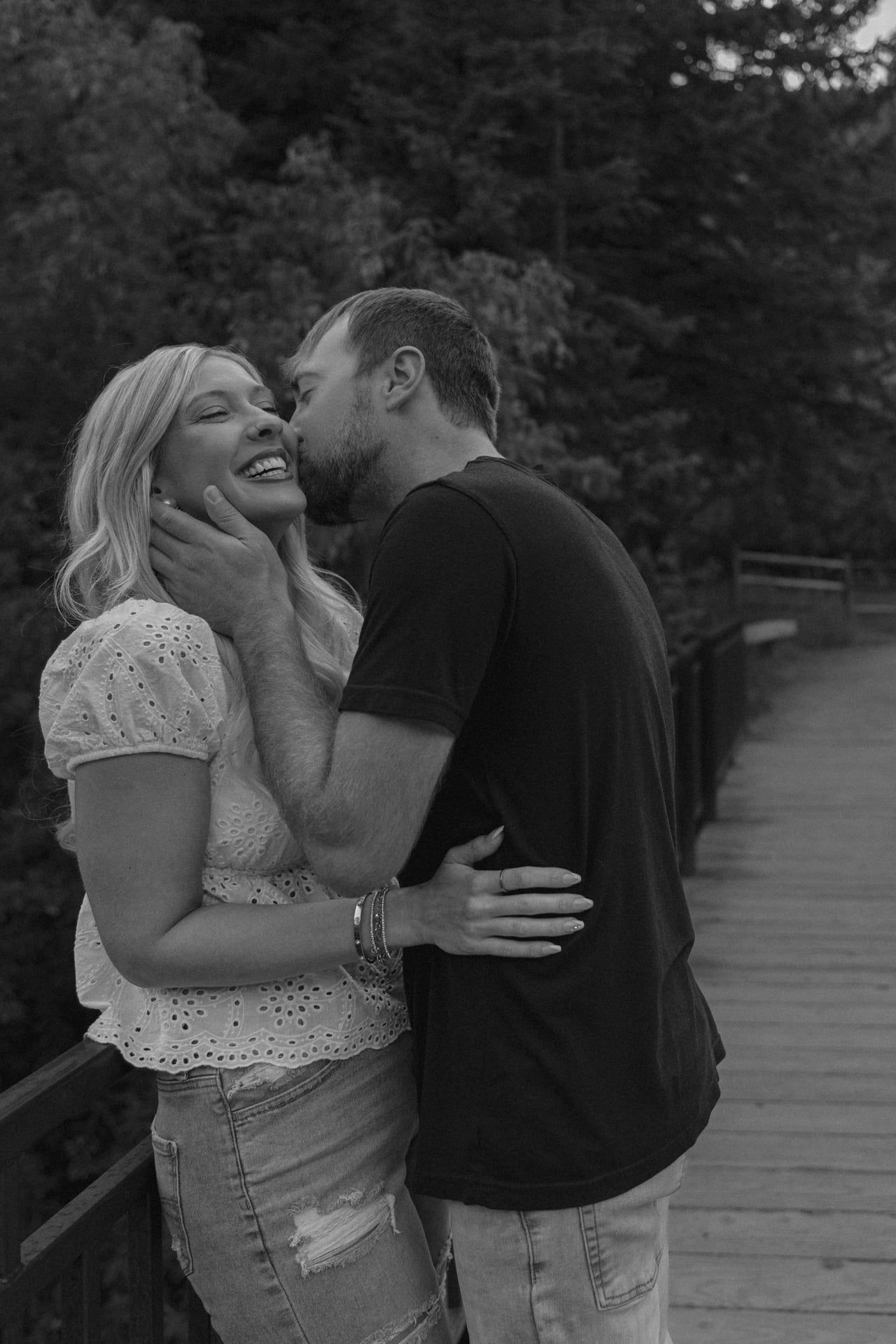 man kissing his fiancee on the cheek in spearfish