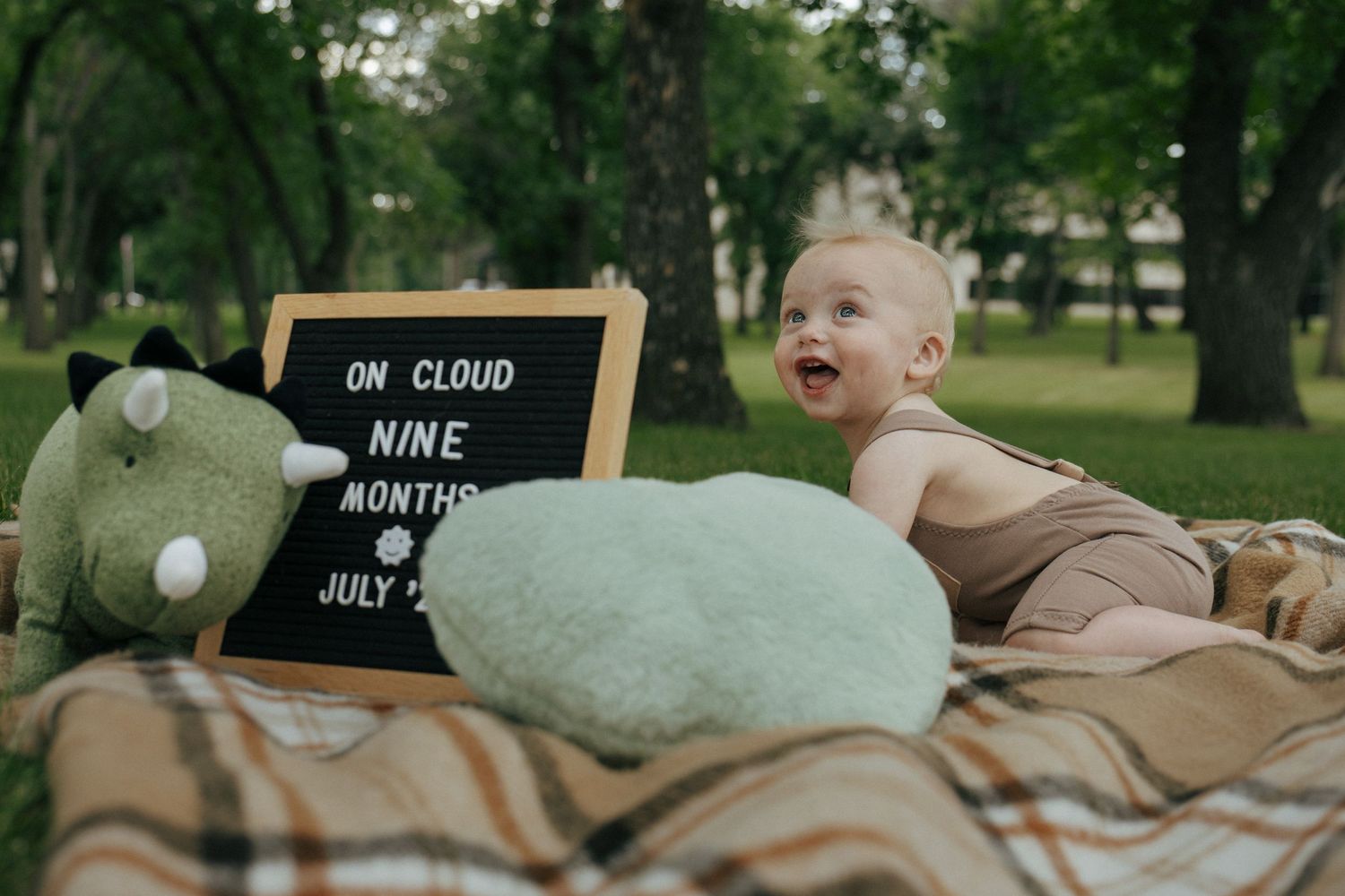 baby laughing on blanket on the capitol grounds in Bismarck North Dakota