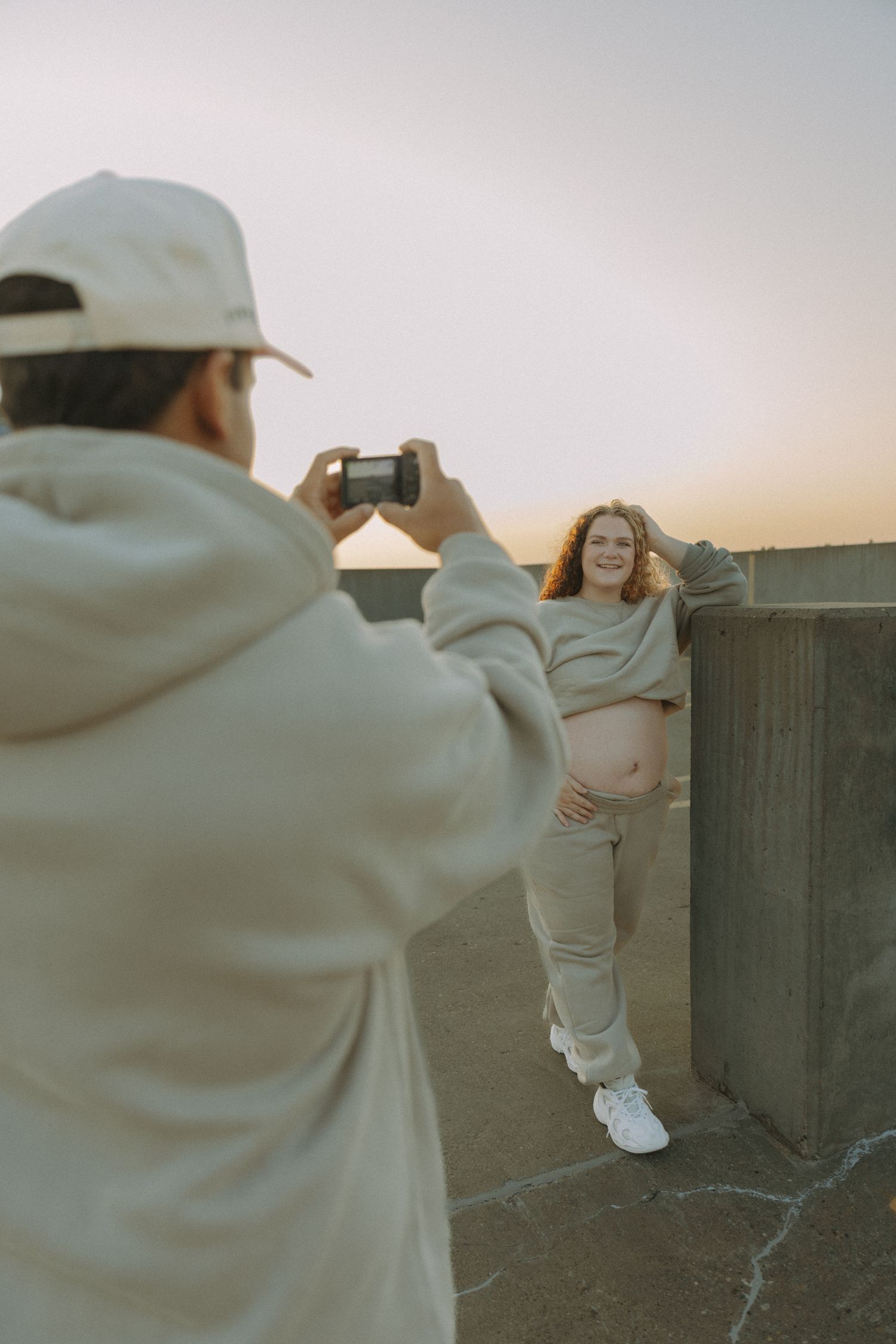dad taking photo of mom to be for maternity session