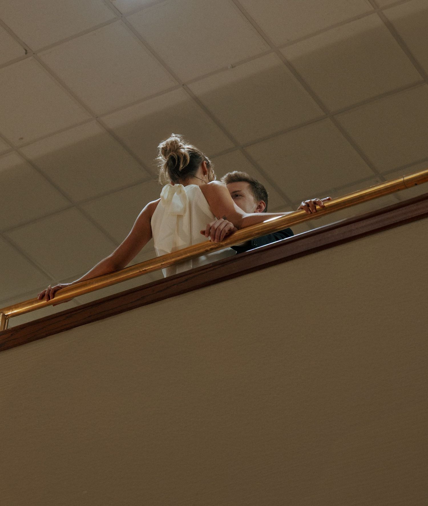 couple admiring each other with girl over railing in Raddison hotel in Bismarck