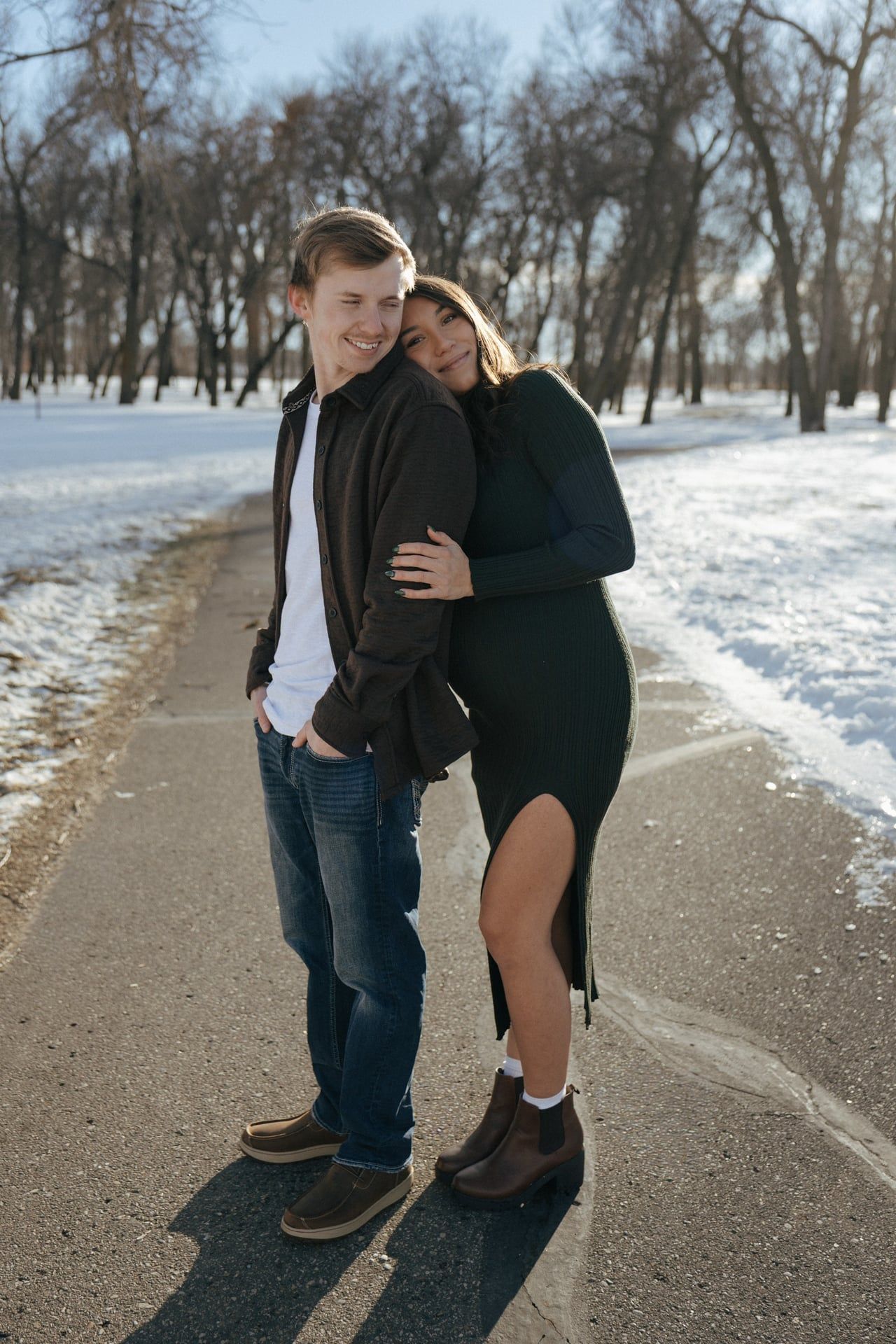 Couple smiling looking at each other in snowy park in Bismarck