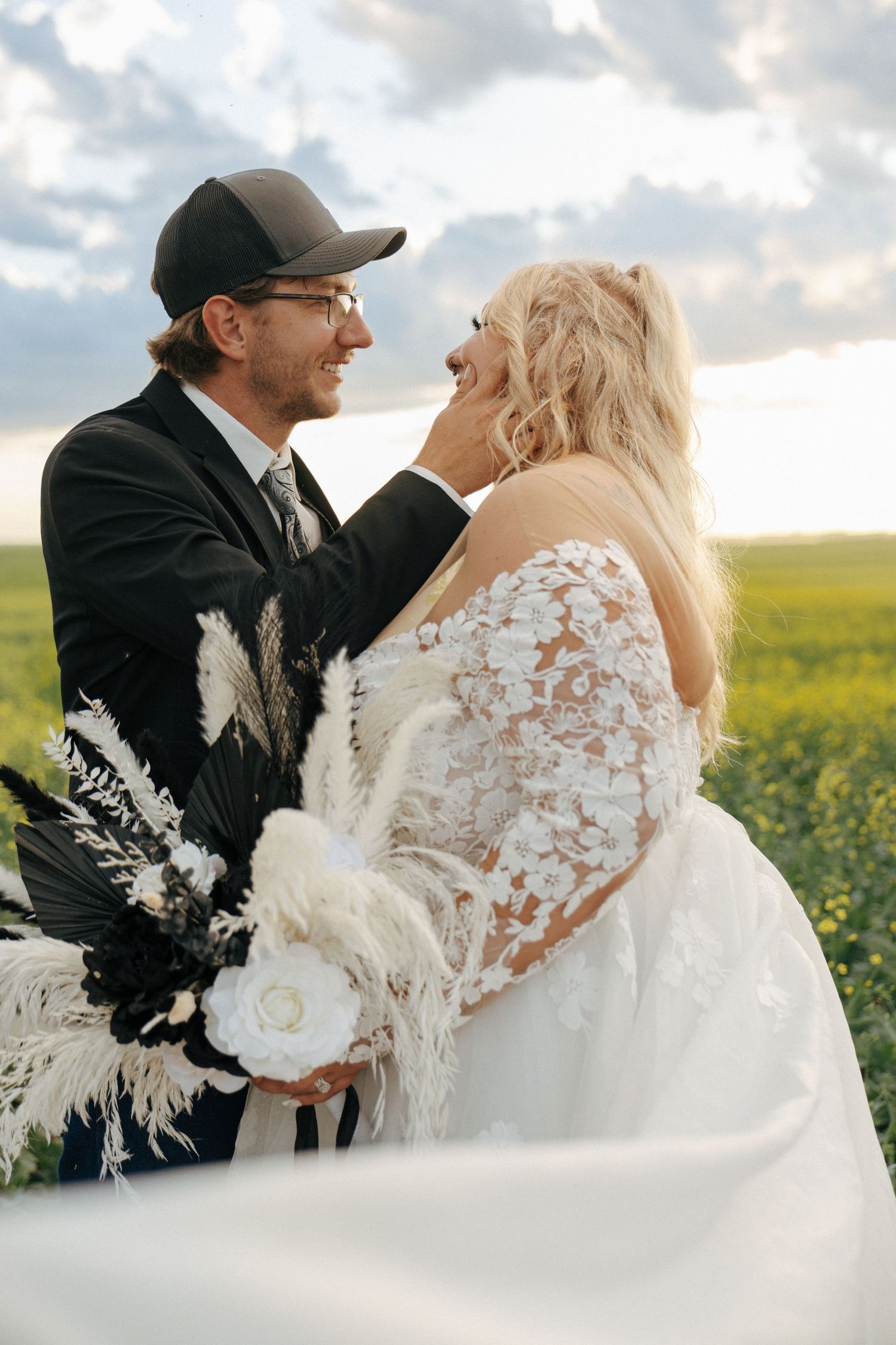 Groom holding brides face gently for kiss on wedding day in Garrison