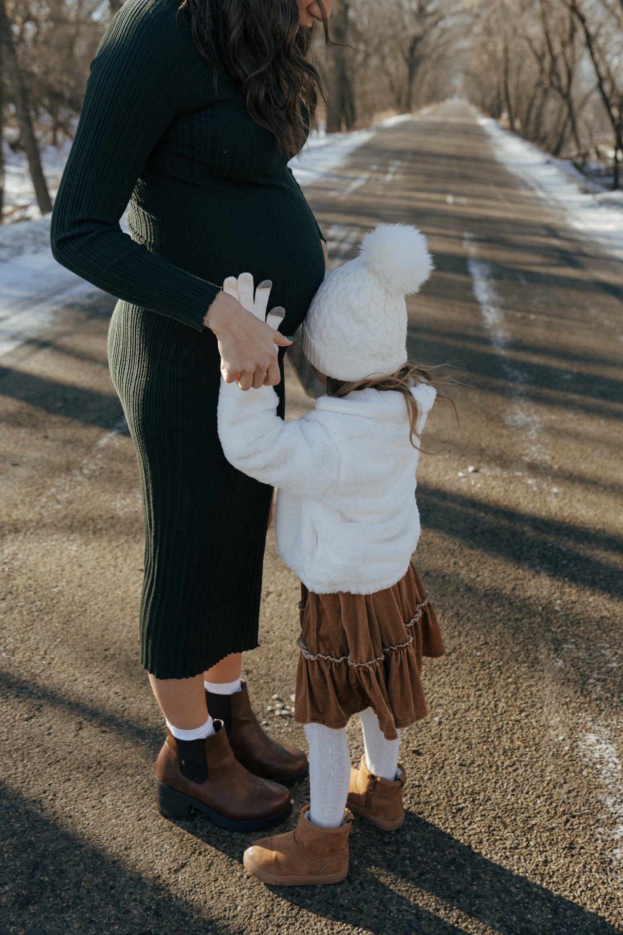 photos of mother to be with daughter in snowy trees in Bismarck