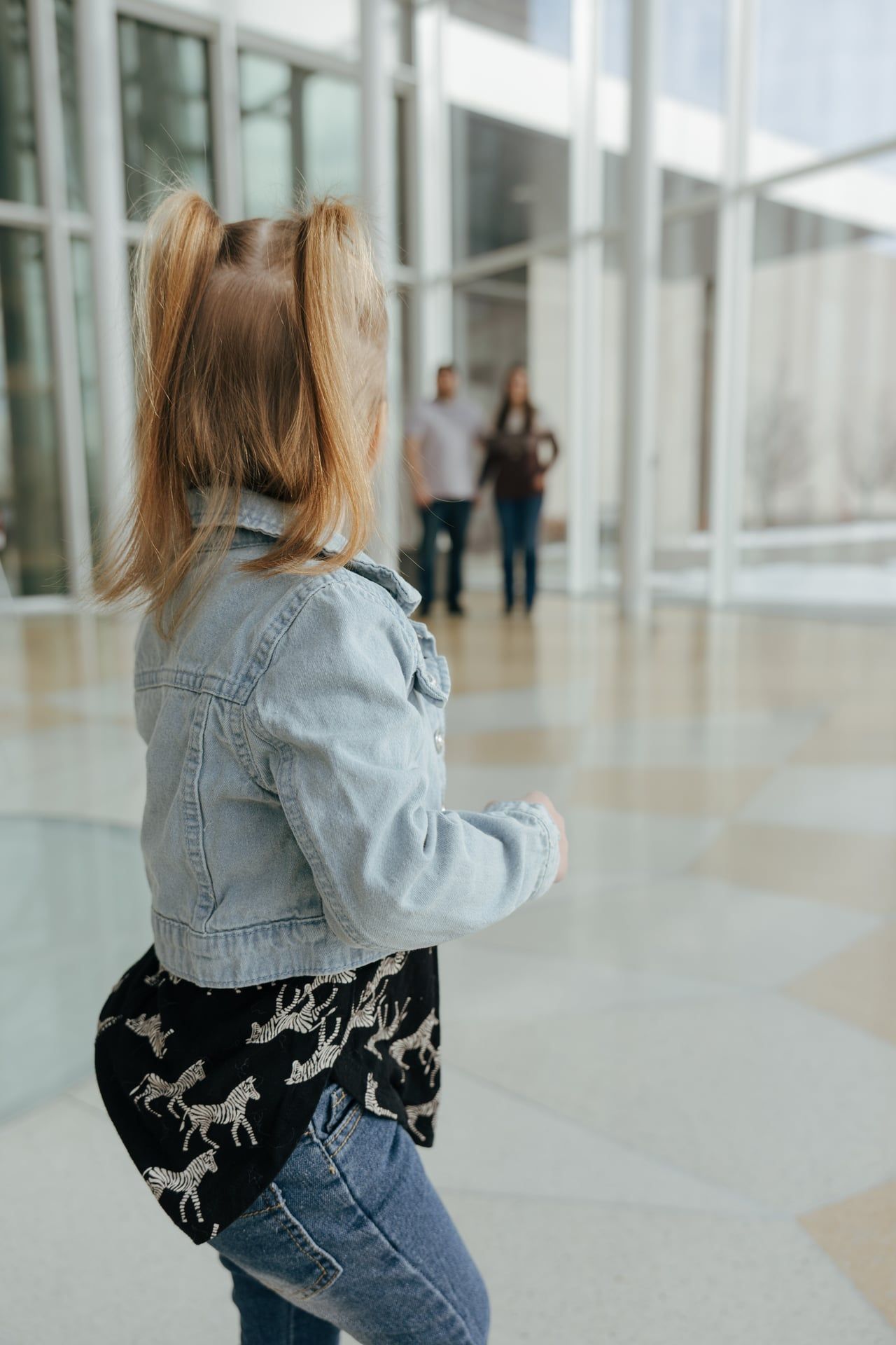 toddler looking at parents before she runs over to them
