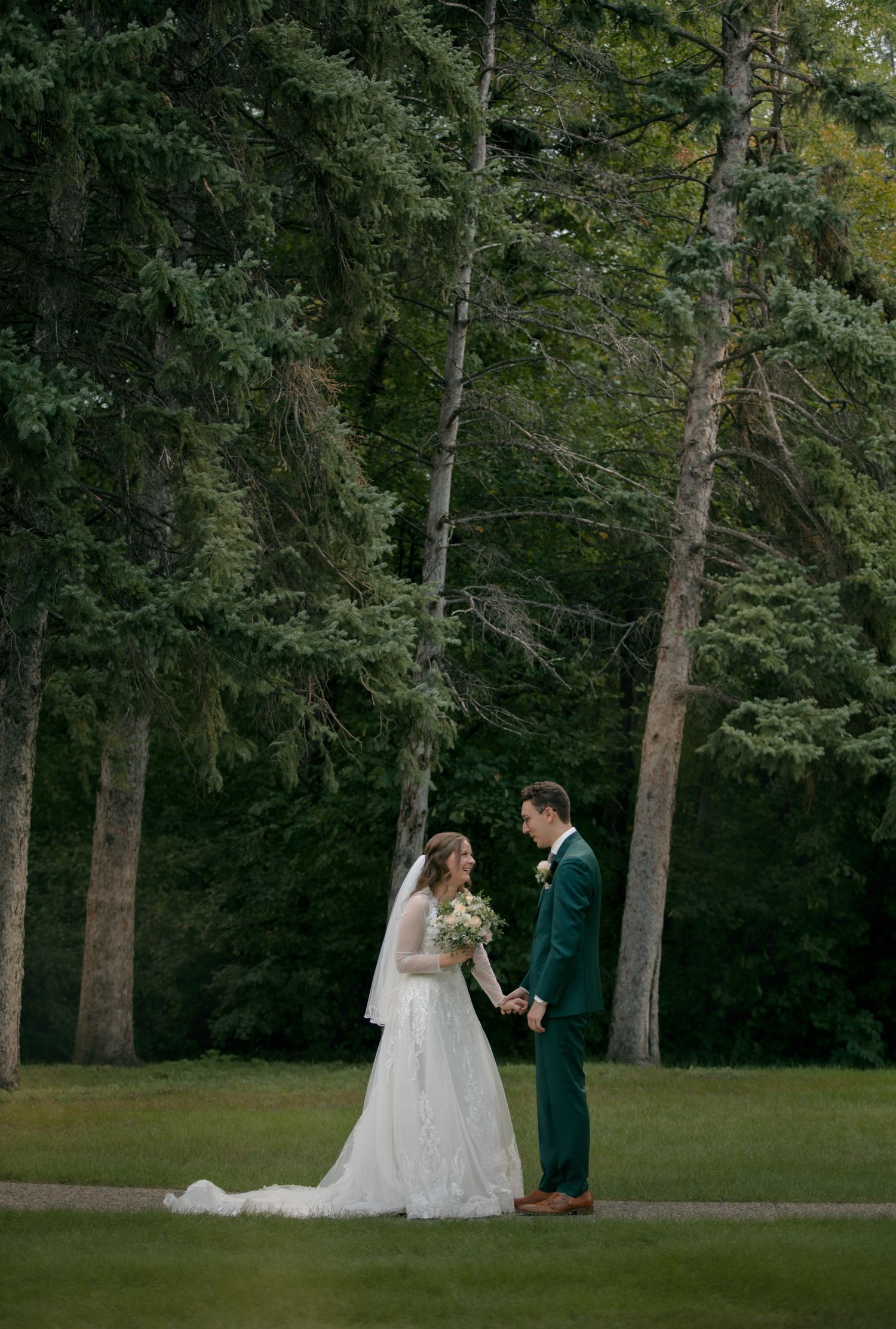 A romantic wedding photo sequence showing a couple in a wooded outdoor setting with tall trees.