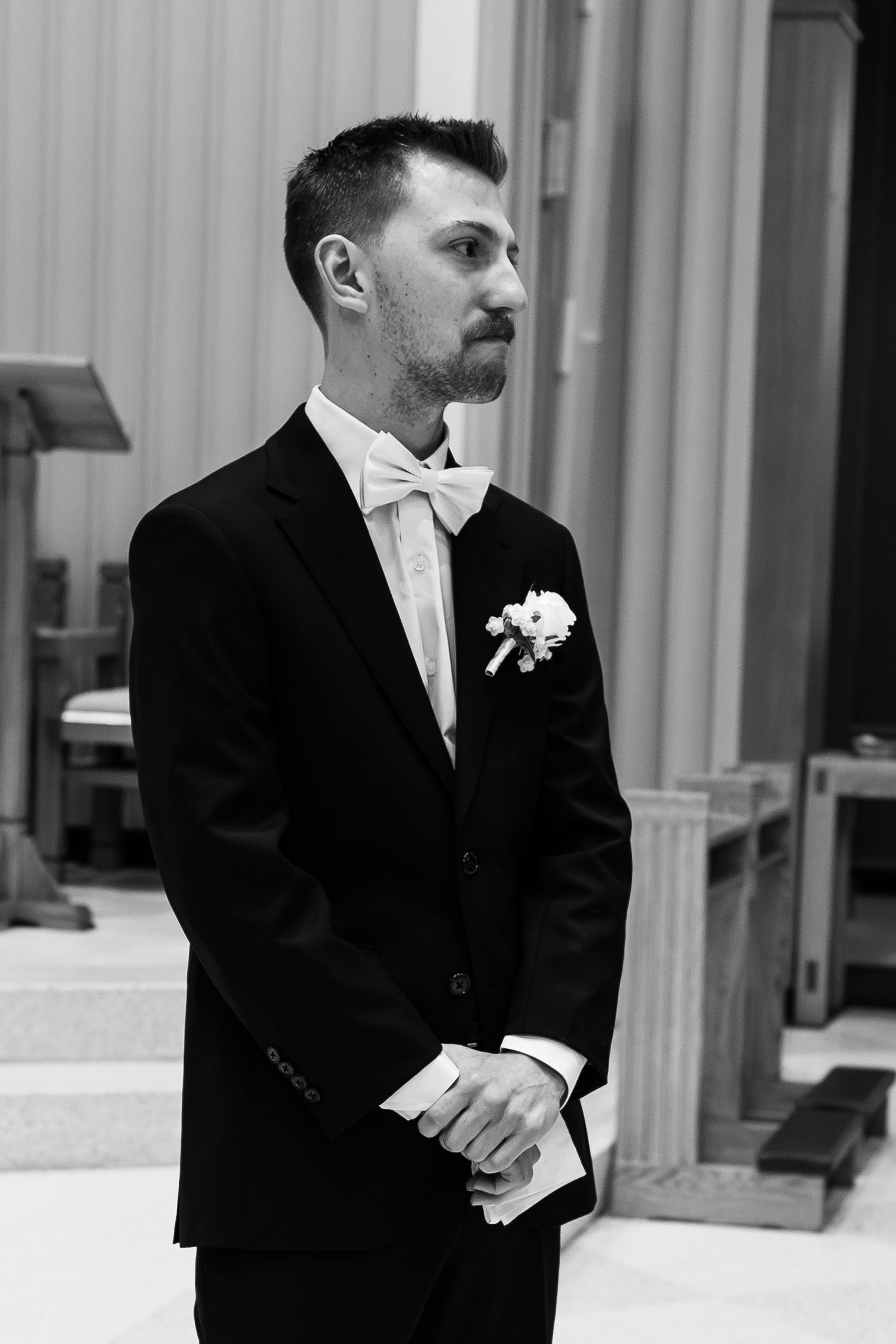 groom watching his bride walk down the aisle