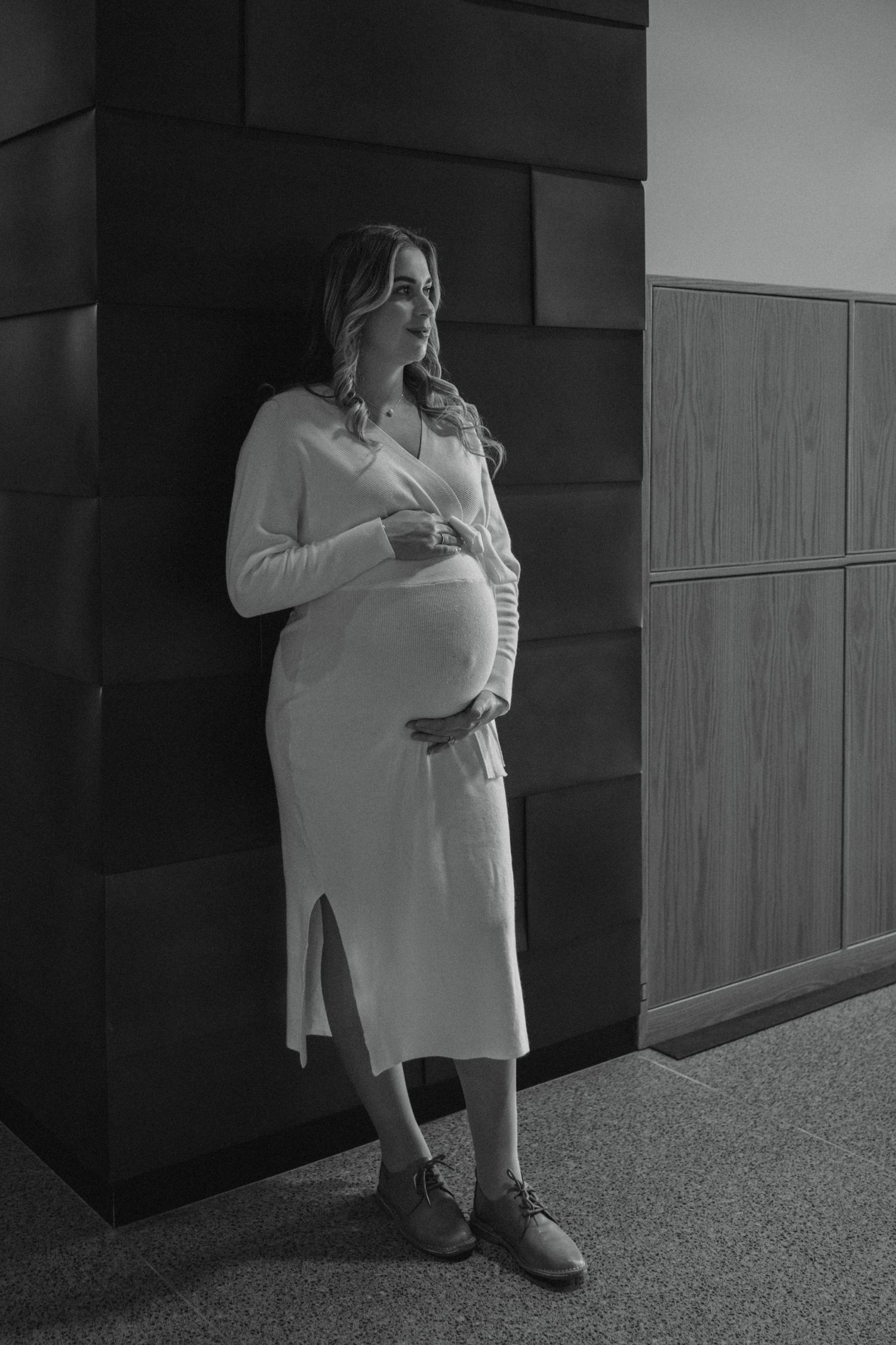 mom to be holding baby bump