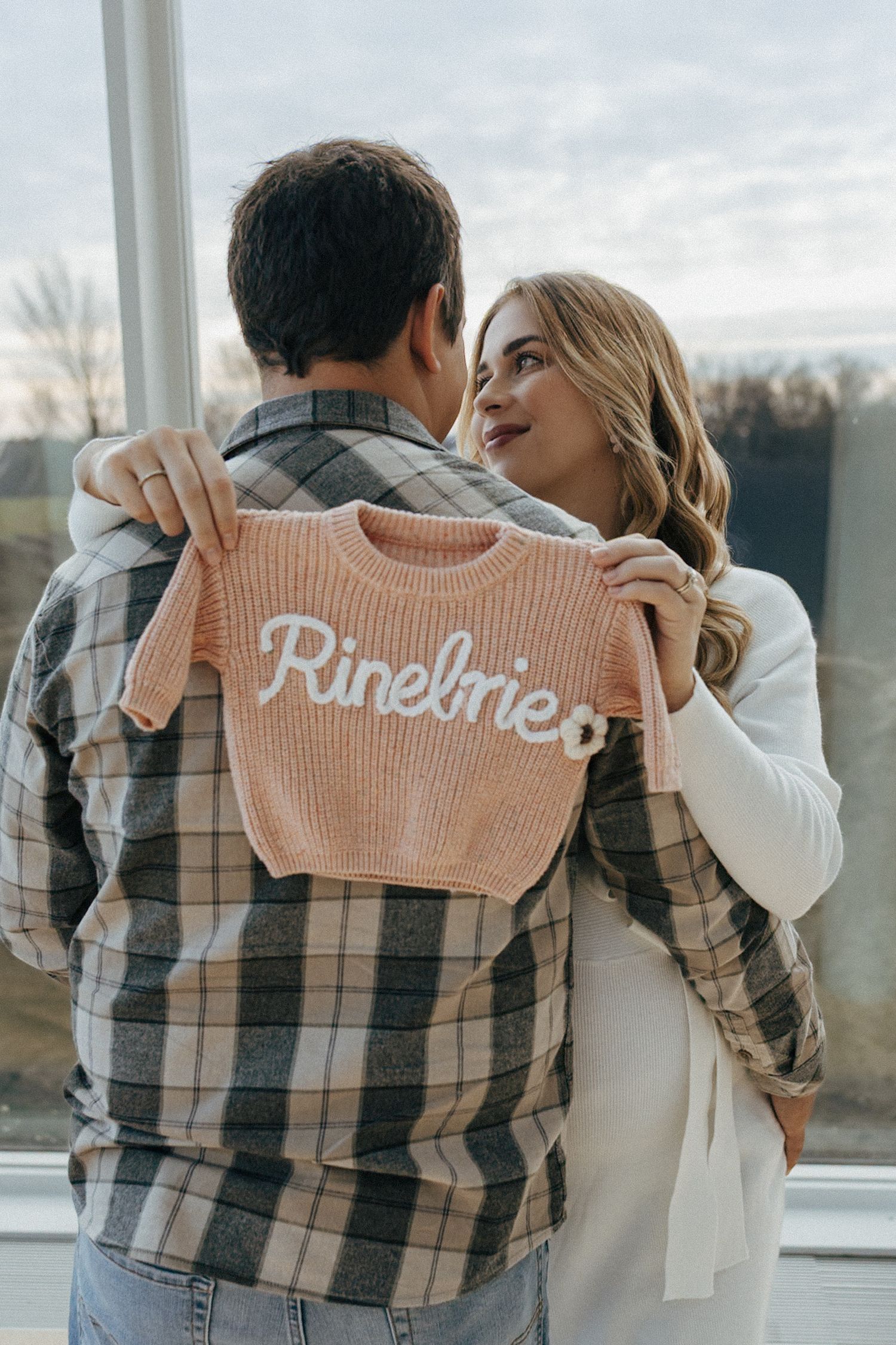 couple holding baby sweater in the Heritage Center in Bismarck