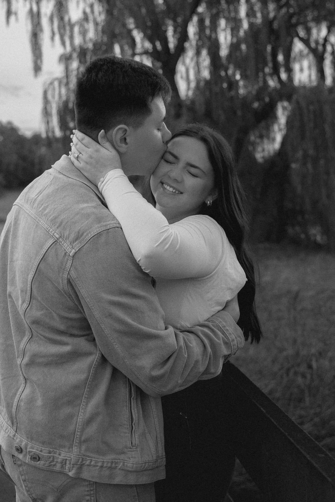 couple kissing and girl laughs