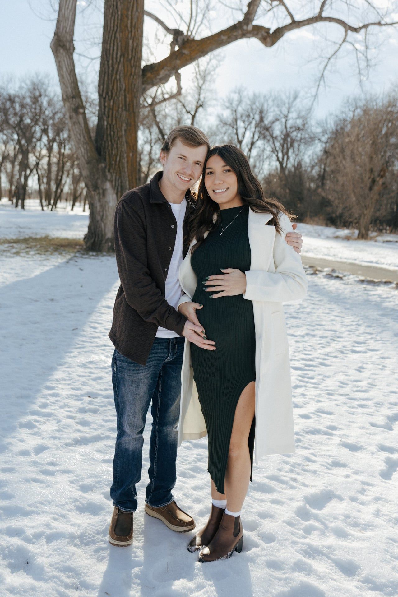 Couple smiling at camera in snowy park in Bismarck