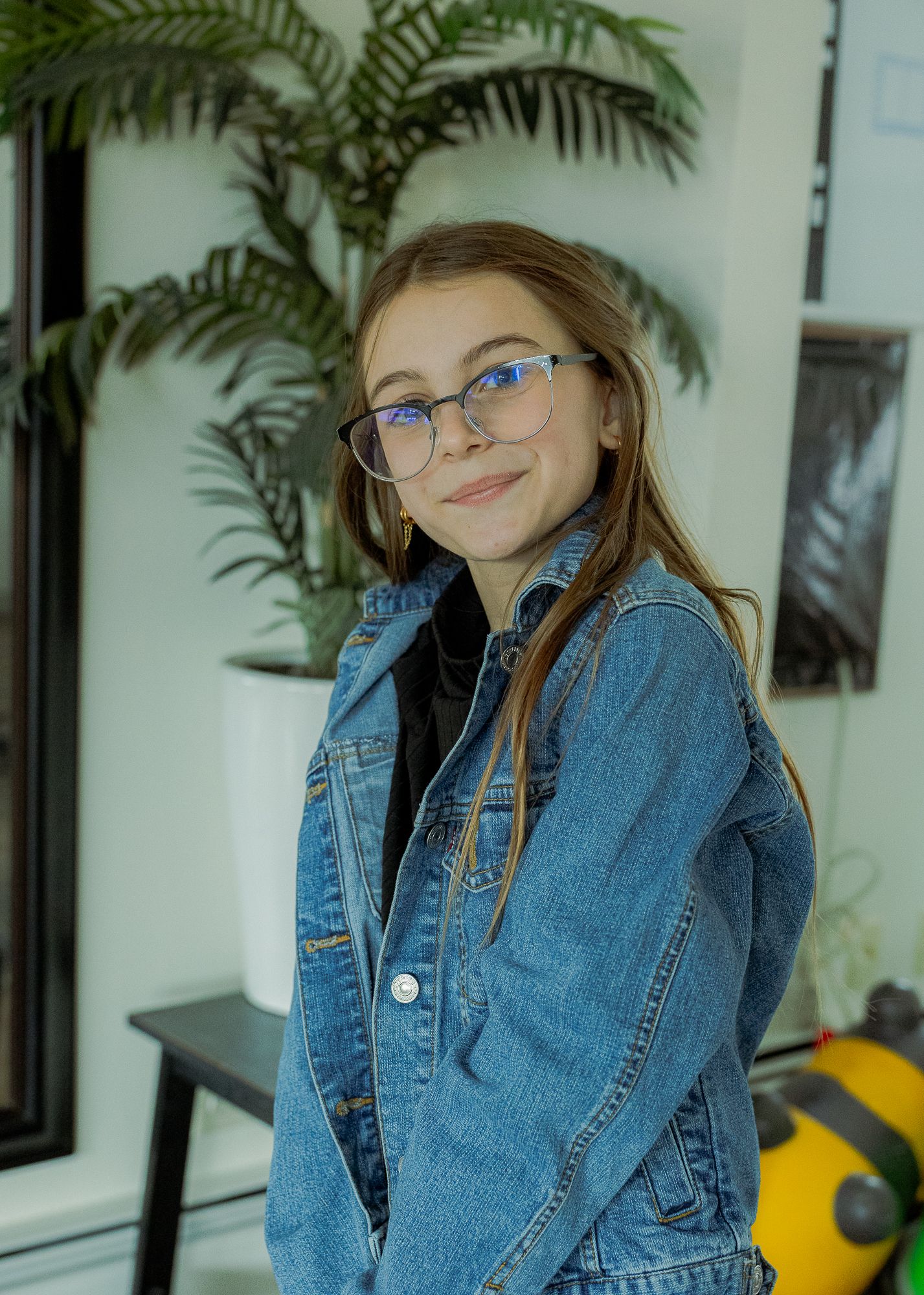 young girl smiling at camera at home