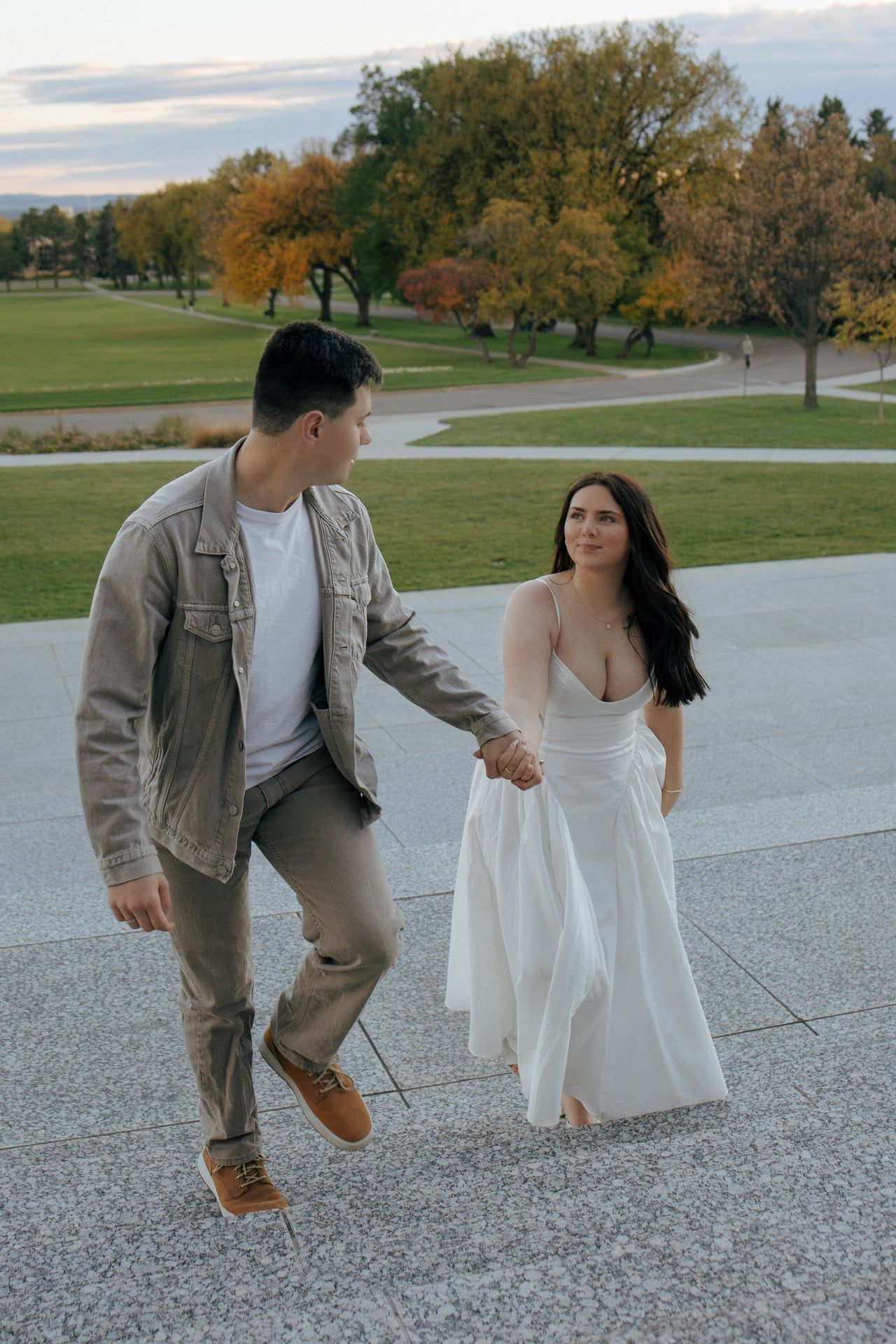 couple walking up stairs on Bismarck capitol grounds for engagement session
