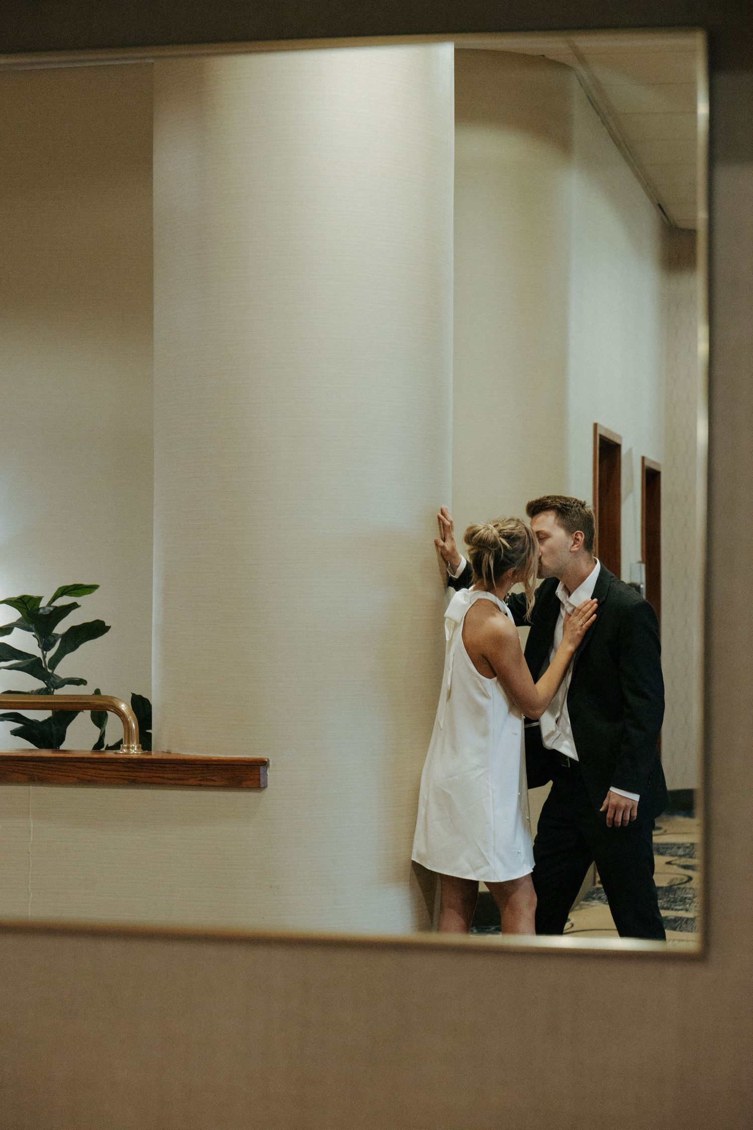 couple kissing in mirror for engagement photos