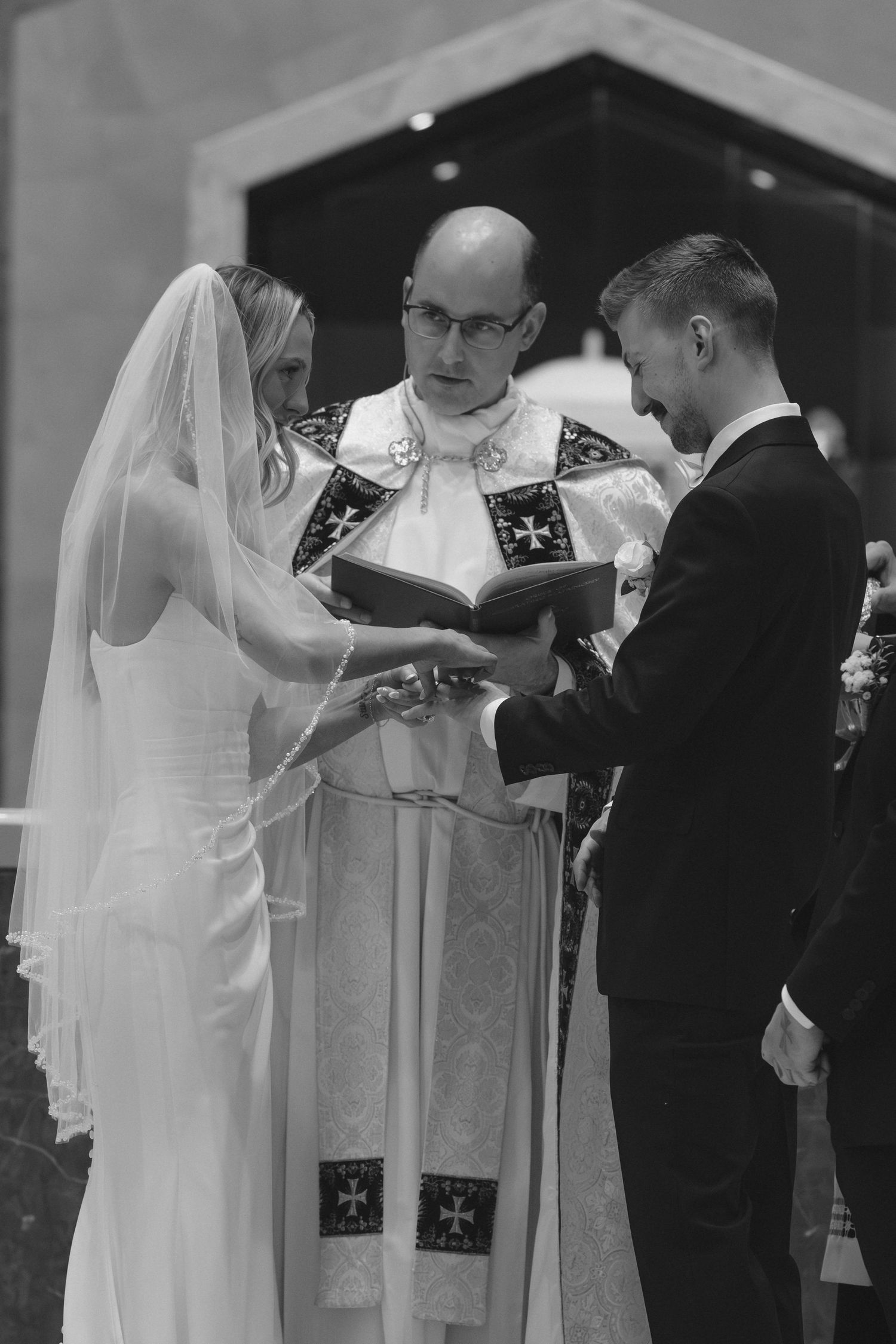 A wedding ceremony in progress with clergy and couple at the altar.