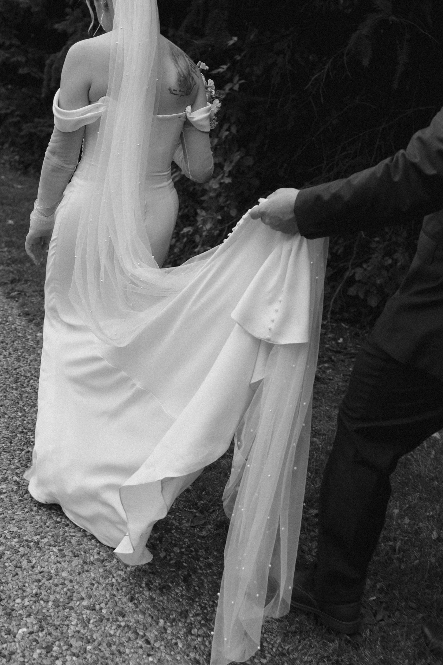 groom holding brides dress