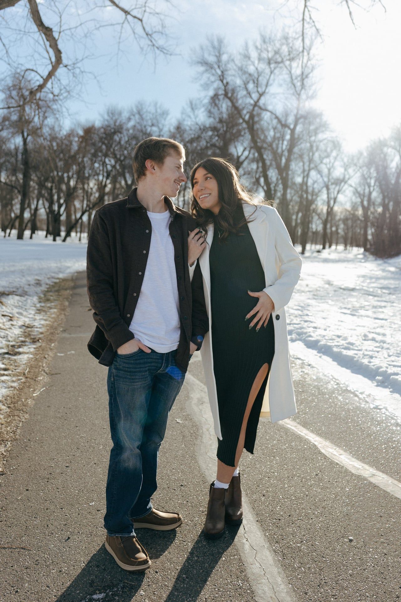 Couple smiling at each other in snowy park