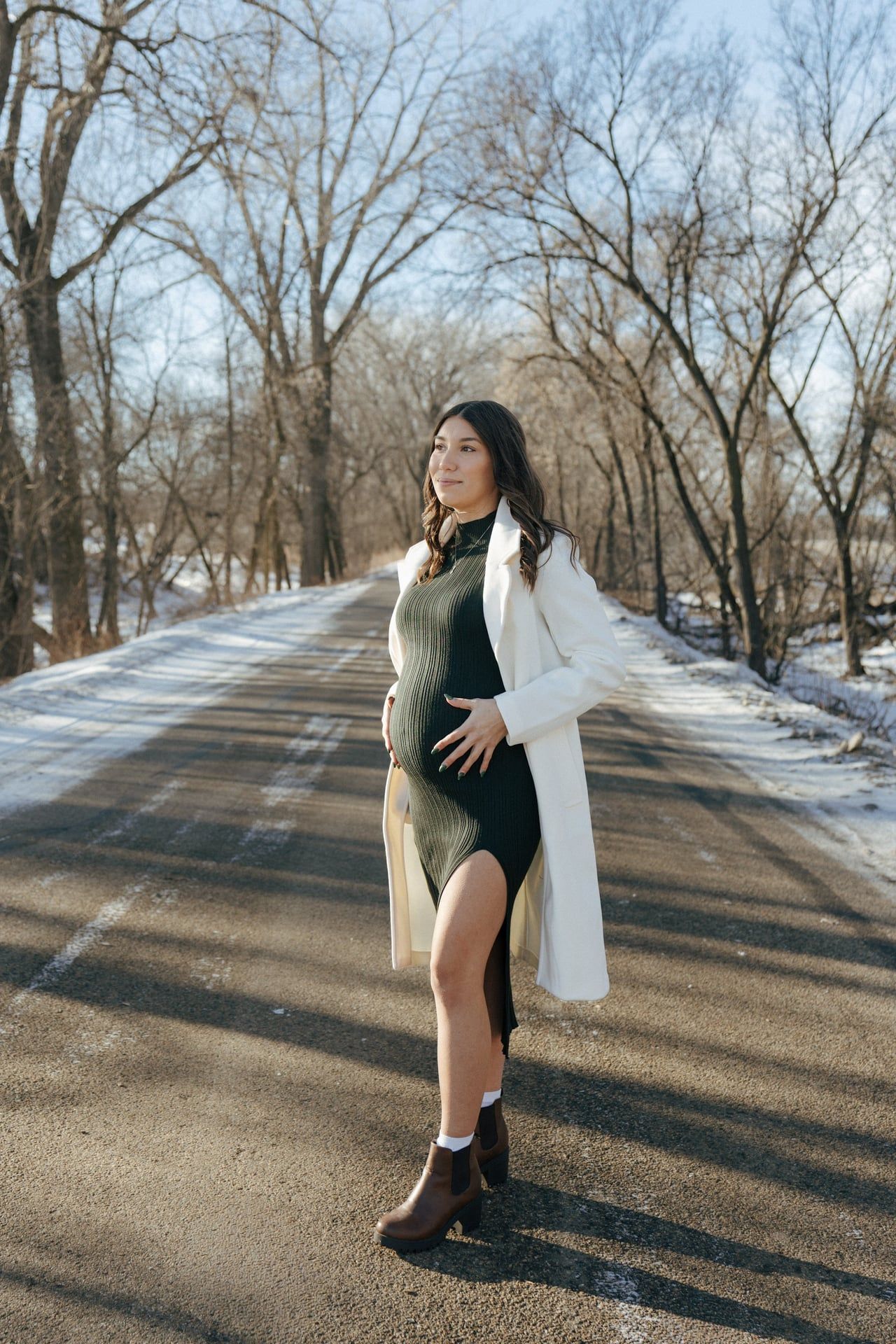 photos of mother to be in snowy trees in Bismarck