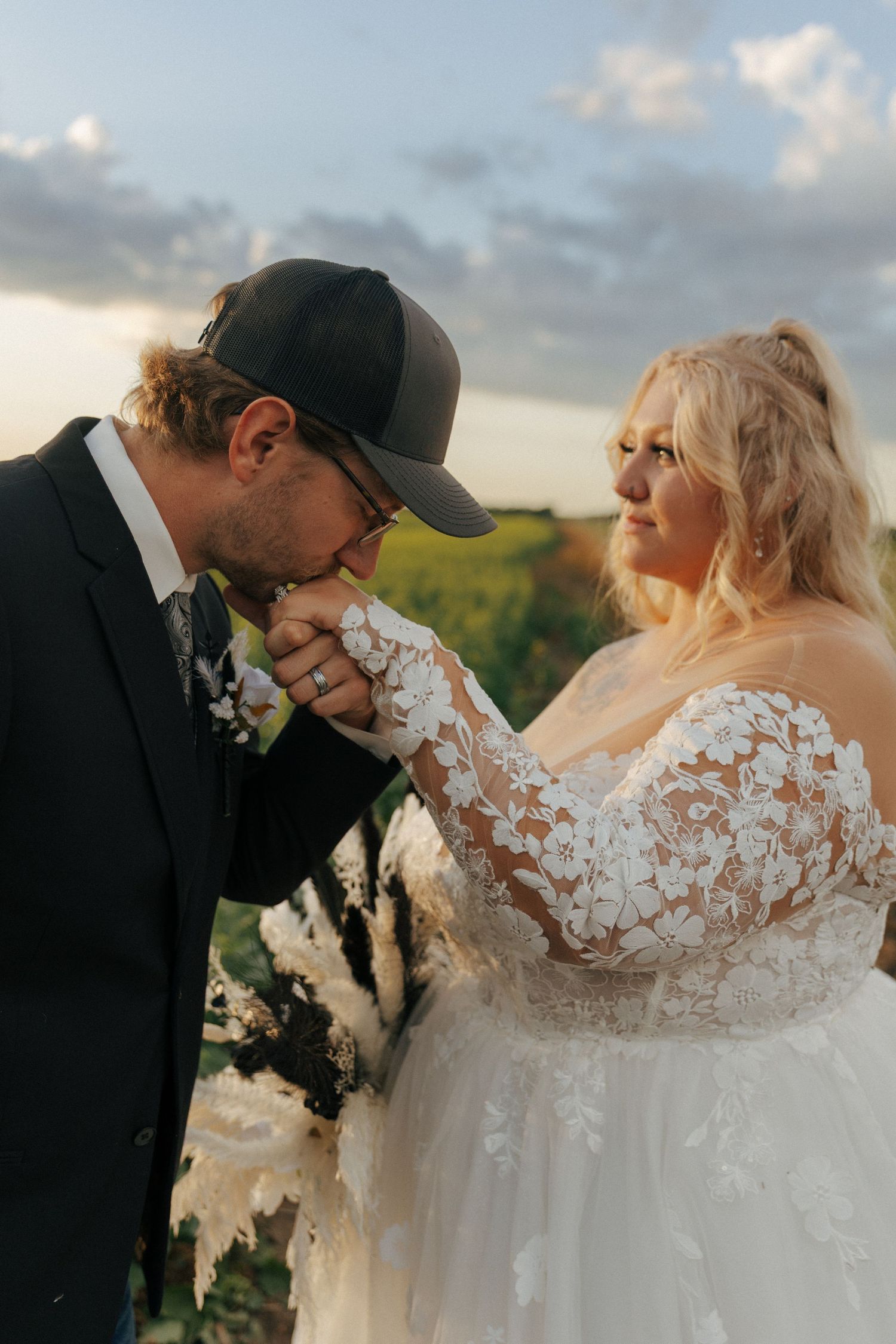 Wedding couple sharing intimate moments in a scenic outdoor setting.