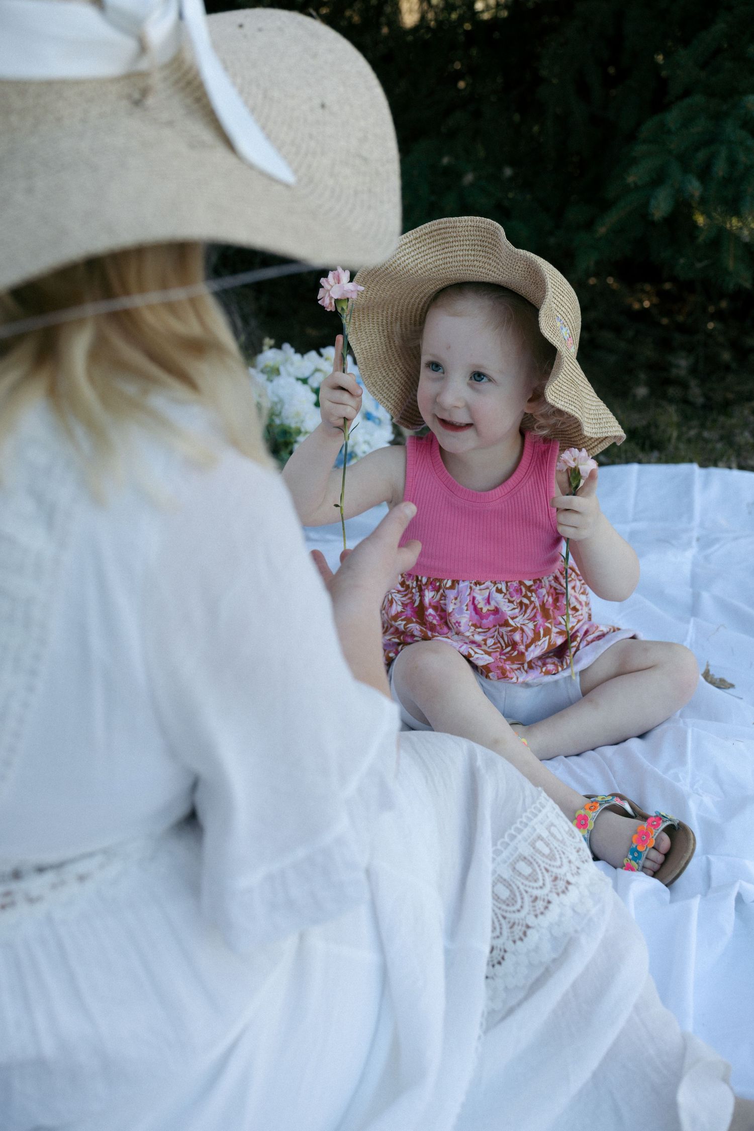 daughter holding up flowers to show mom